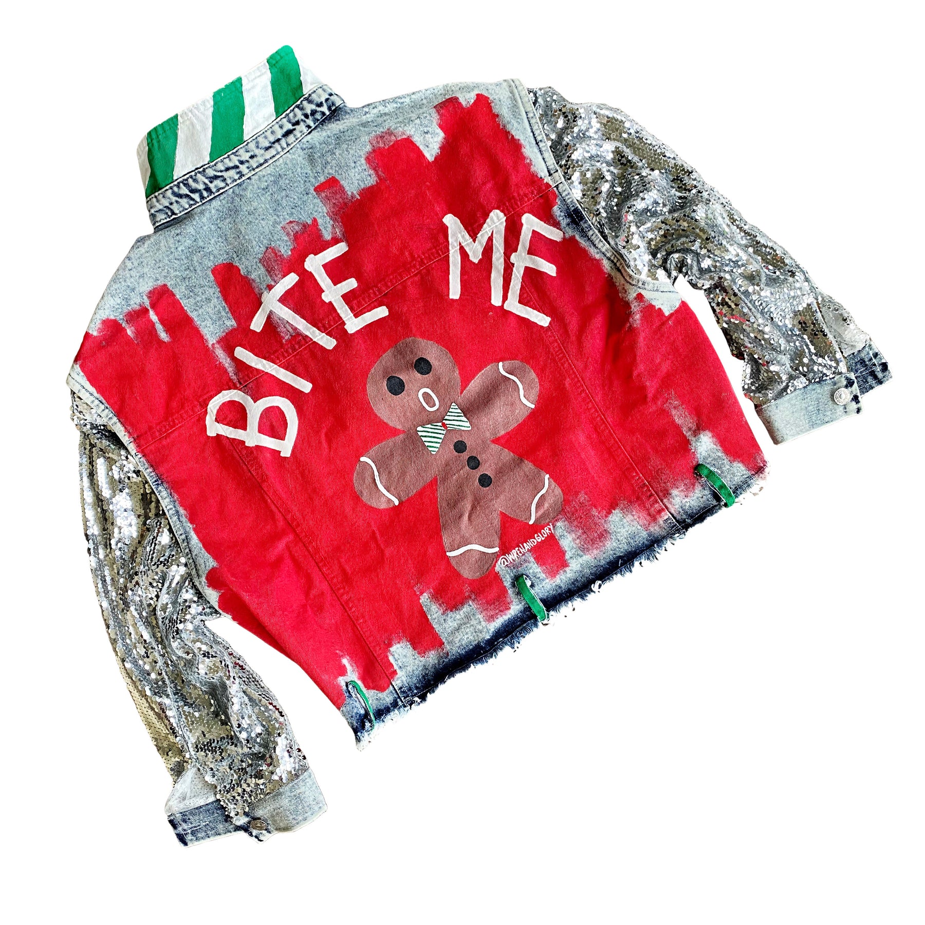 Blue denim jacket with sequined sleeves. Red base painted throughout, with gingerbread man on back, and BITE ME in semi circle above it. Signed @wrenandglory.
