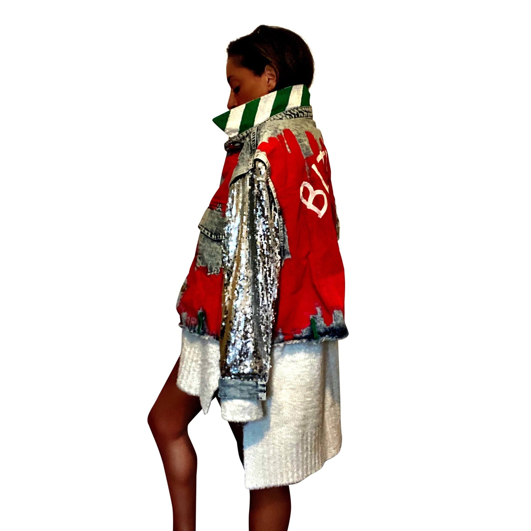 Blue denim jacket with sequined sleeves. Red base painted throughout, with gingerbread man on back, and BITE ME in semi circle above it. Signed @wrenandglory.
