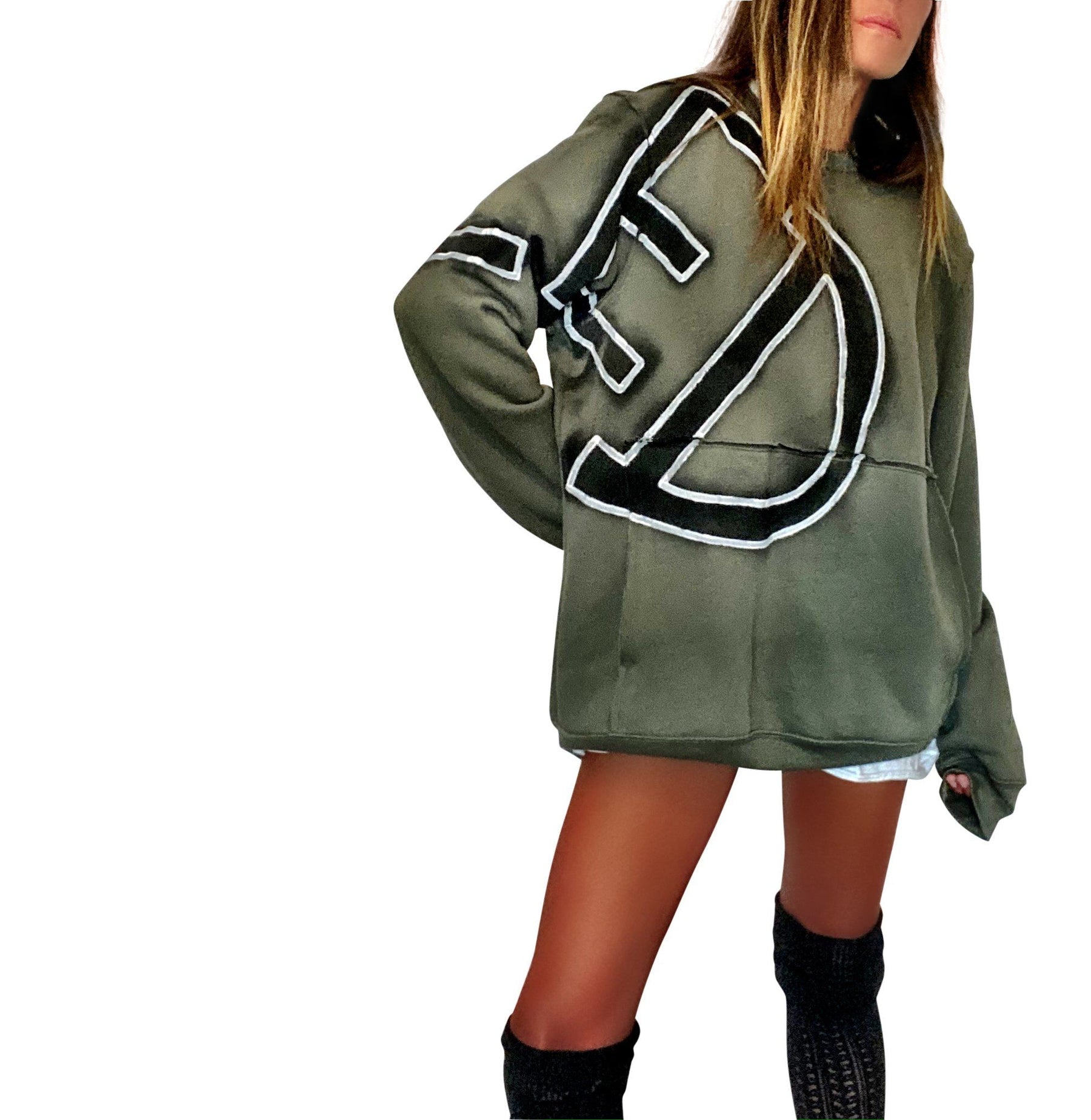 Army green or Tan crewneck sweatshirt. CANCELED painted in black spray paint, with white outline, overlapping from front to back. Signed @wrenandglory.