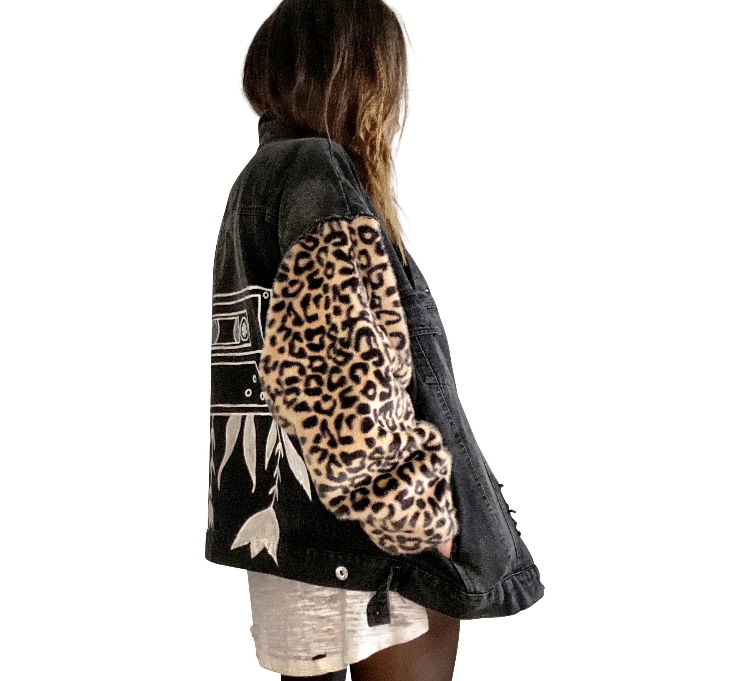 Black denim jacket with super comfortable leopard pattern sleeves. Large white cassette tape painted on back, with white flowers and leaves sprouting out. Signed @wrenandglory.