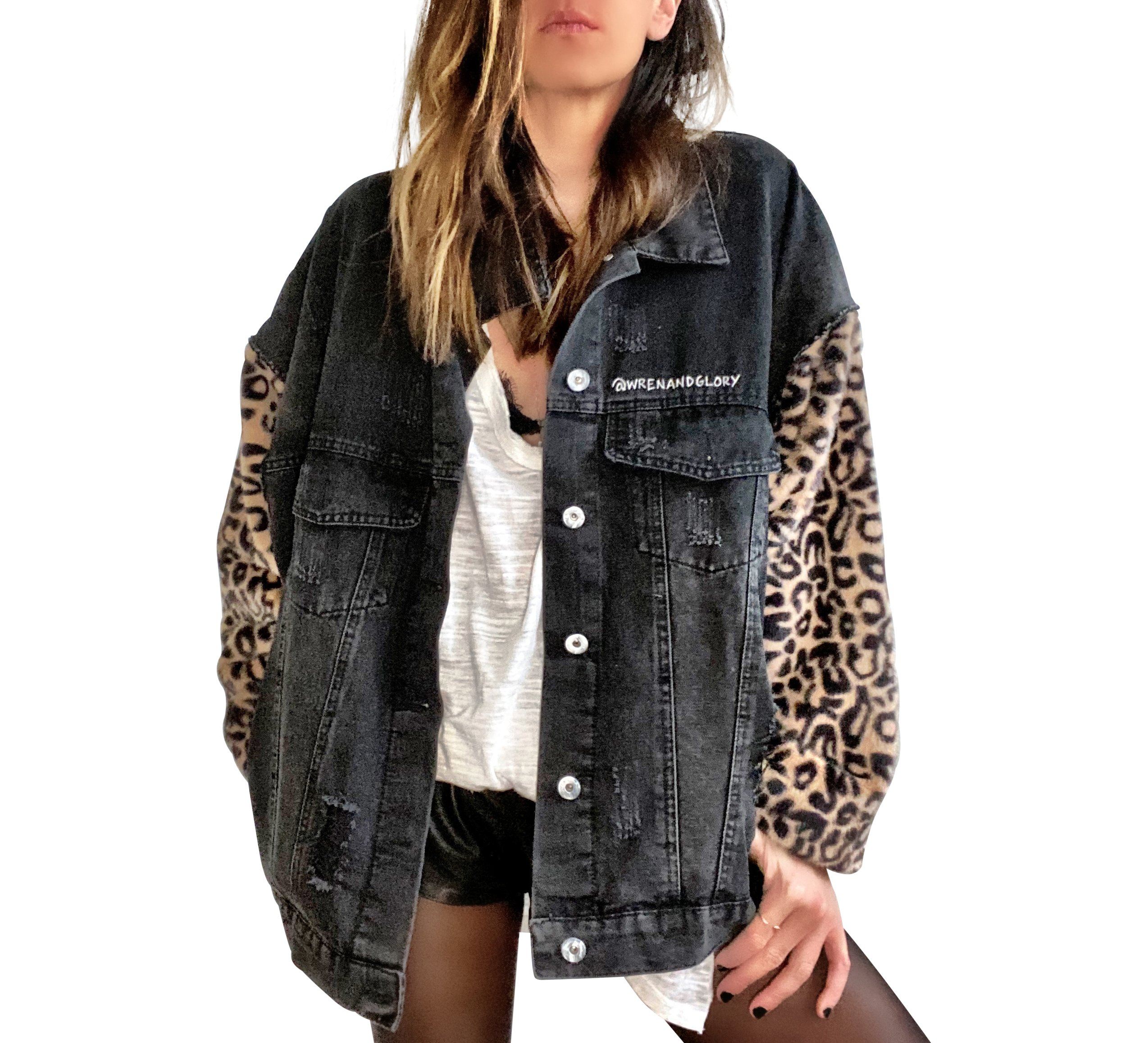 Black denim jacket with super comfortable leopard pattern sleeves. Large white cassette tape painted on back, with white flowers and leaves sprouting out. Signed @wrenandglory.