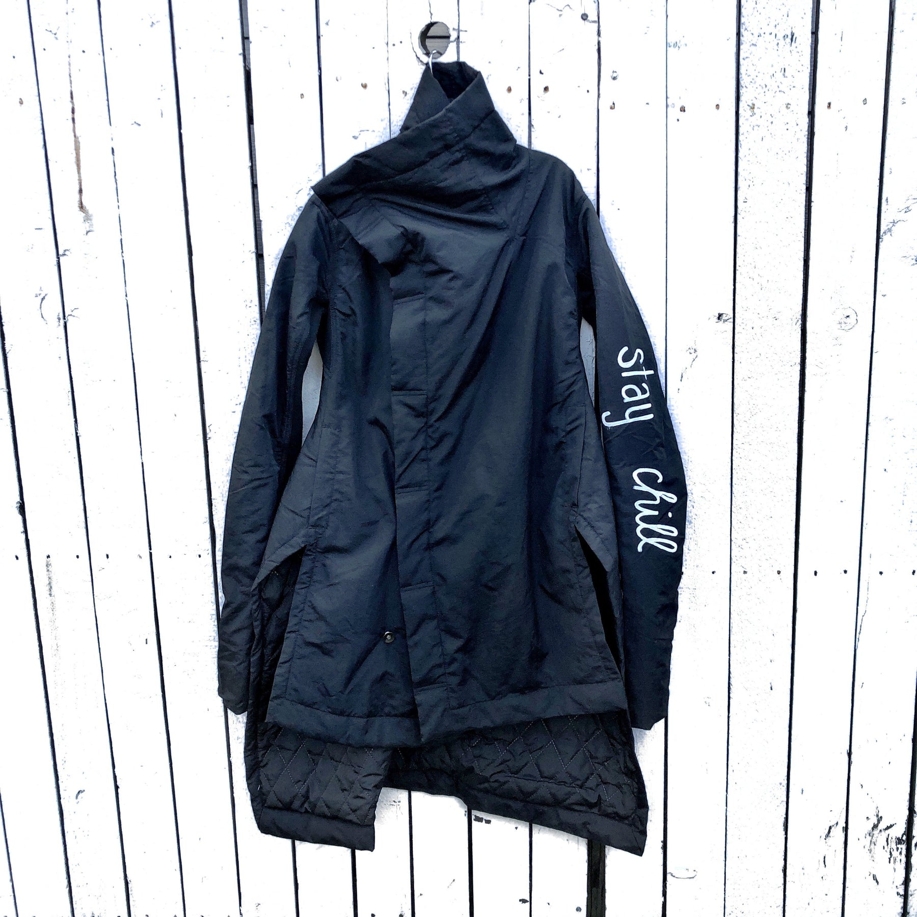 The COOLEST puffer jacket. Large smiley painted on back in yellow, with black drip eyes and mouth. STAY CHILL painted in white on sleeve. Signed @wrenandglory.