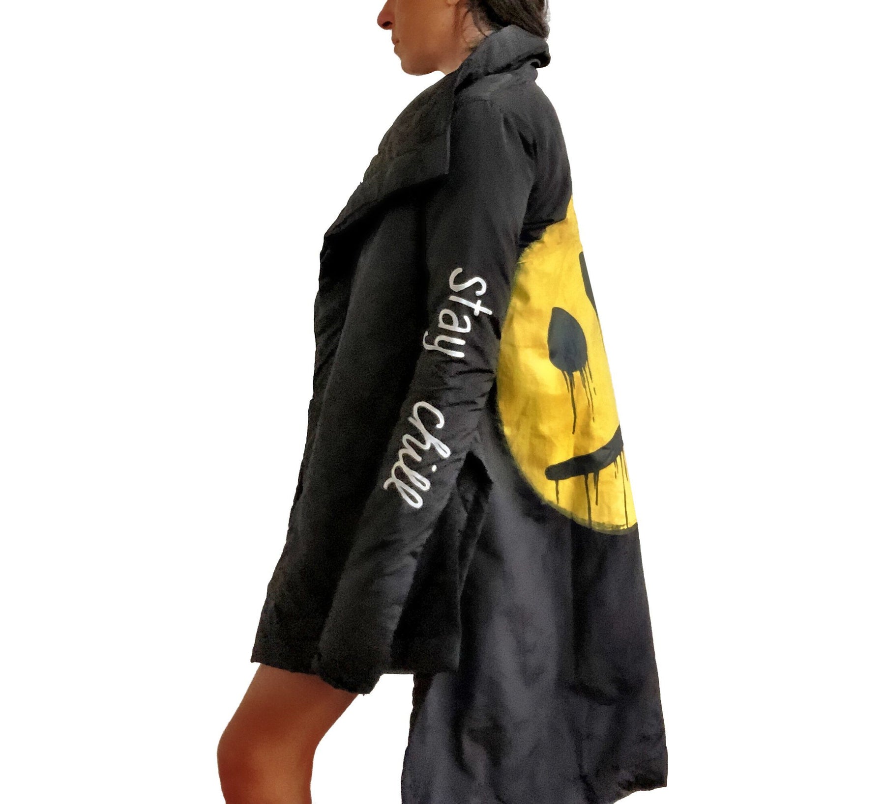 The COOLEST puffer jacket. Large smiley painted on back in yellow, with black drip eyes and mouth. STAY CHILL painted in white on sleeve. Signed @wrenandglory.