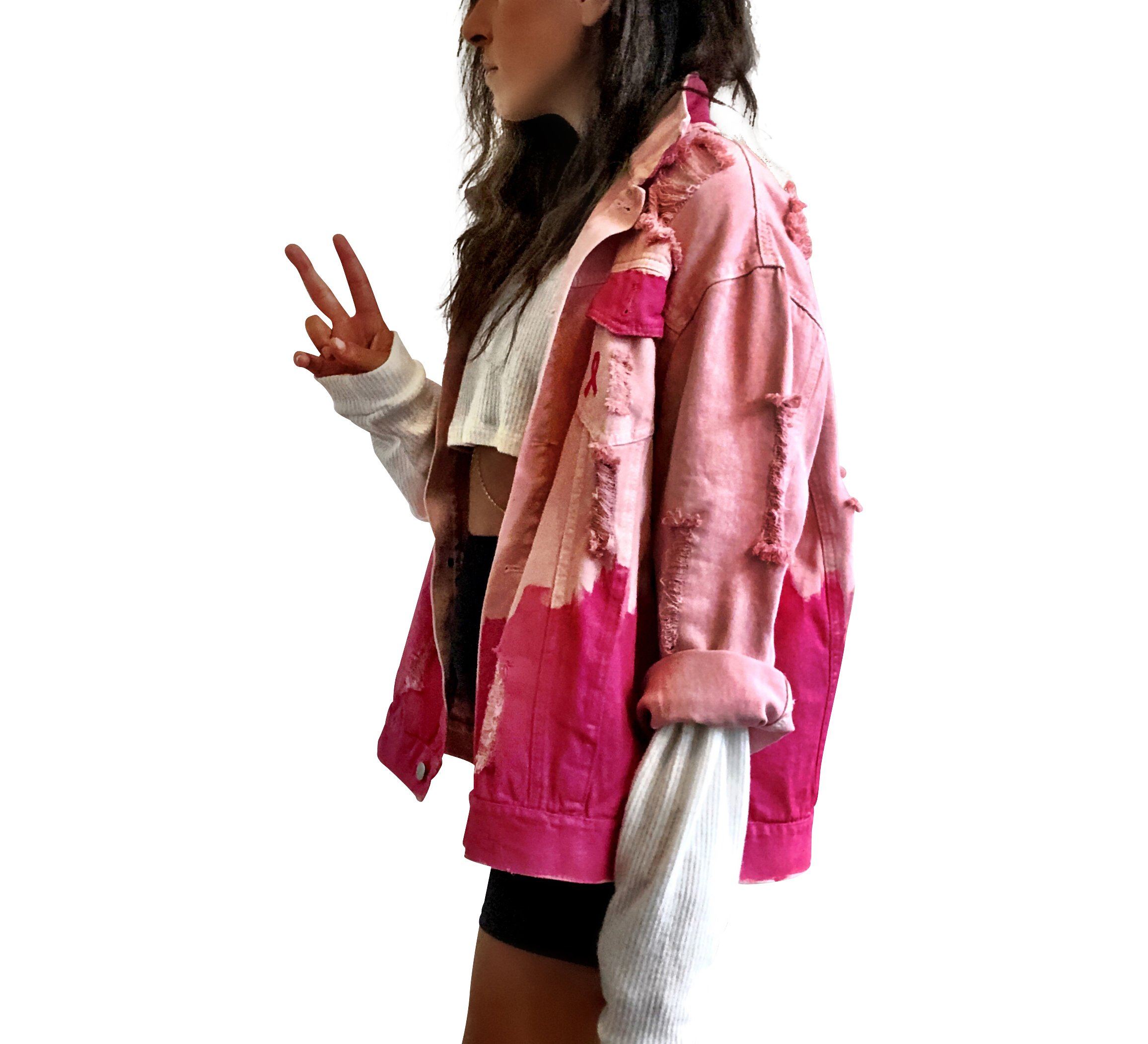 Pink /blush colored denim. Hot pink painted along the bottom half of the jacket, with FIGHT LIKE A GIRL painted in white on back. Small Breast Cancer Awareness ribbon painted on front upper pocket. Signed @wrenandglory.