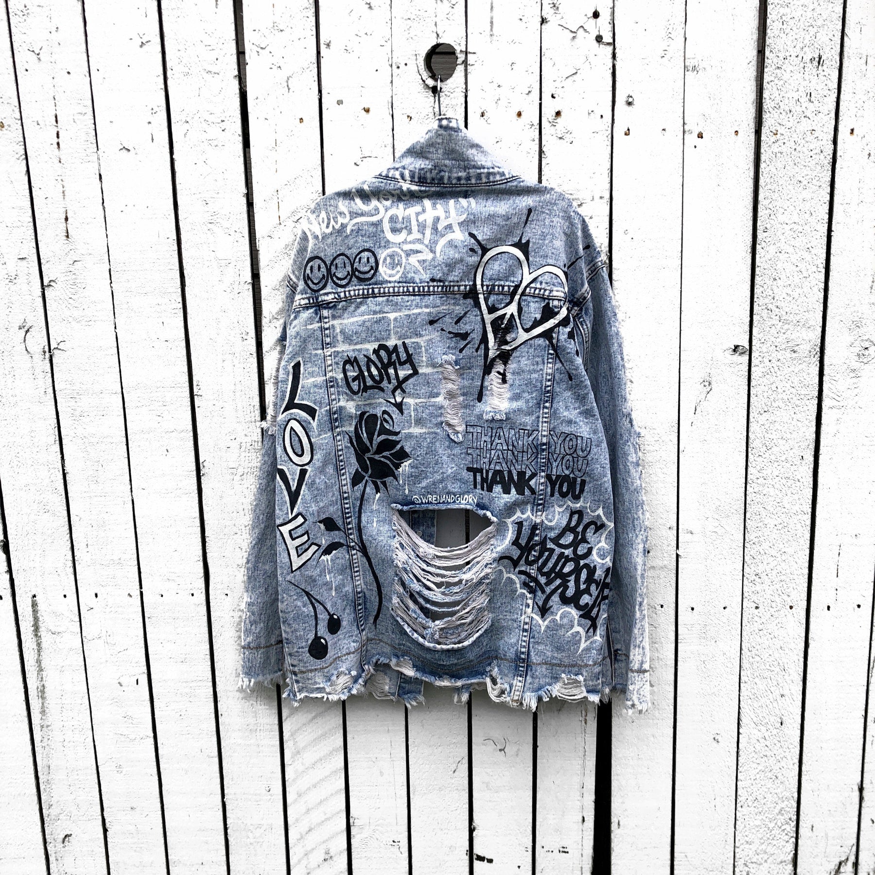 Light blue denim wash. Graffiti style paint throughout entire jacket, in black and white. Choose your name and city to be painted on. Please specify info above. Signed @wrenandglory.