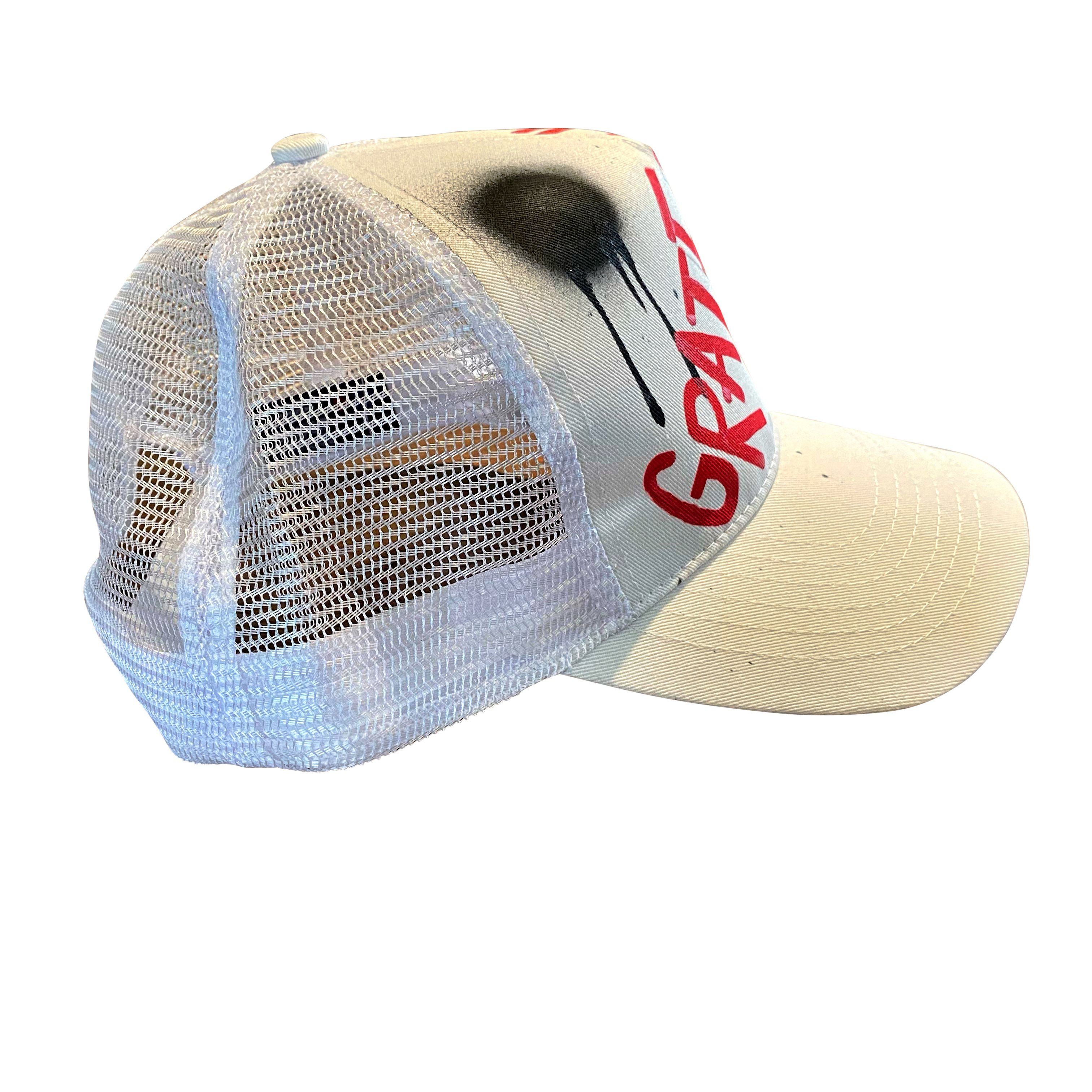 White trucker hat. GRATEFUL painted on hat in red, with black spray paint. Signed @wrenandglory.