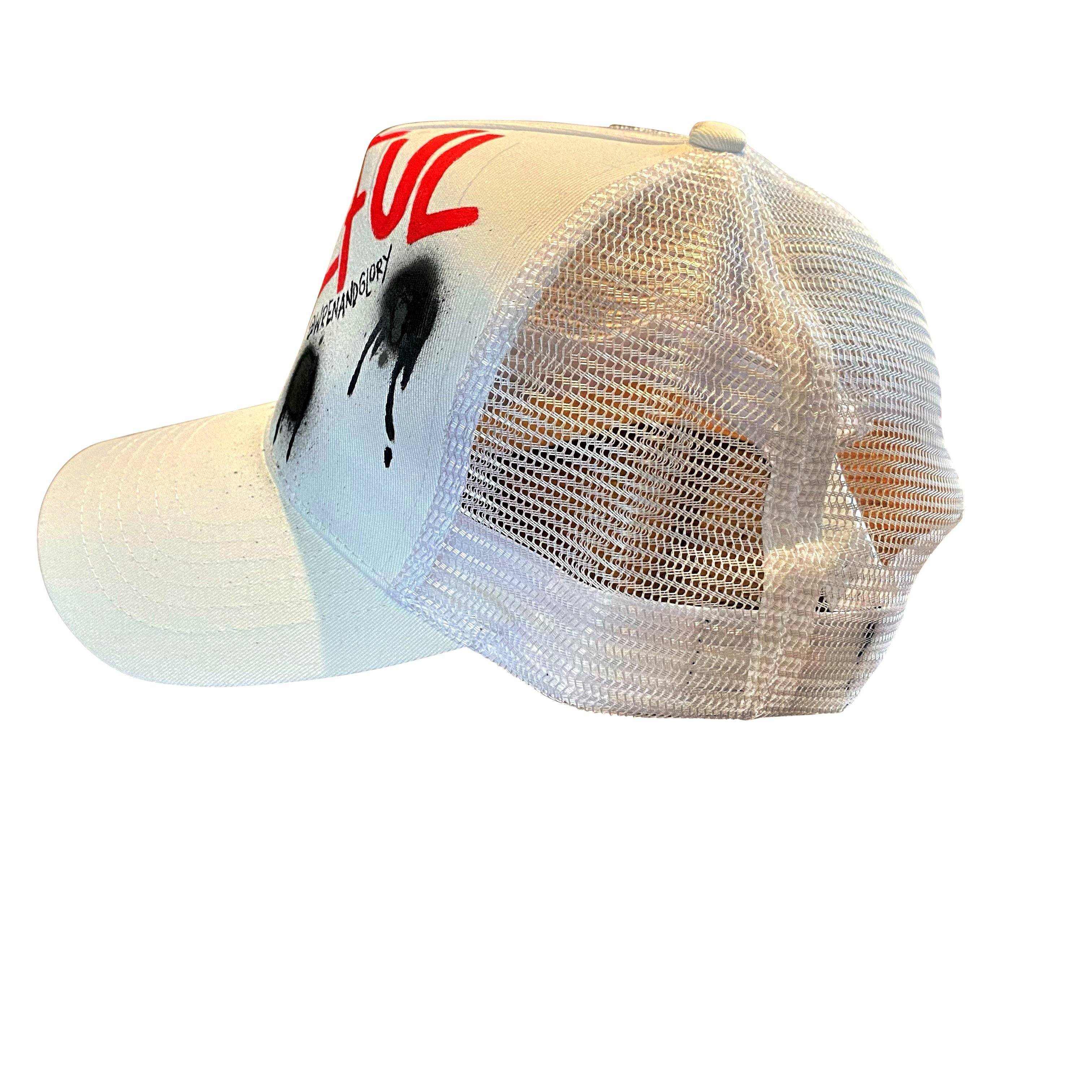 White trucker hat. GRATEFUL painted on hat in red, with black spray paint. Signed @wrenandglory.