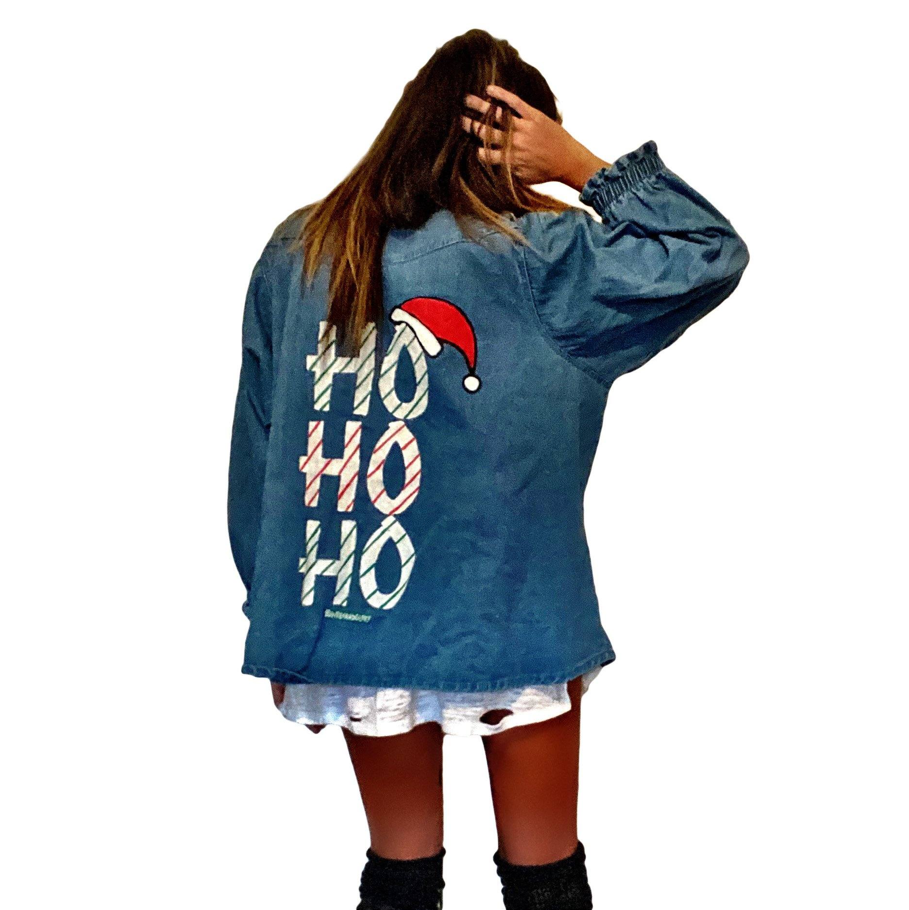 Knit sweater, with denim shirt on back. HO HO HO painted in white, green and red on back with small Santa hat. Signed @wrenandglory.