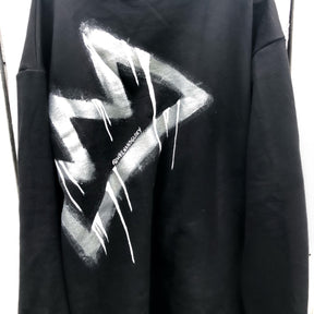 Slight mock neck black sweater. Large silver crown, with white drip effect, on back. Signed @wrenandglory.