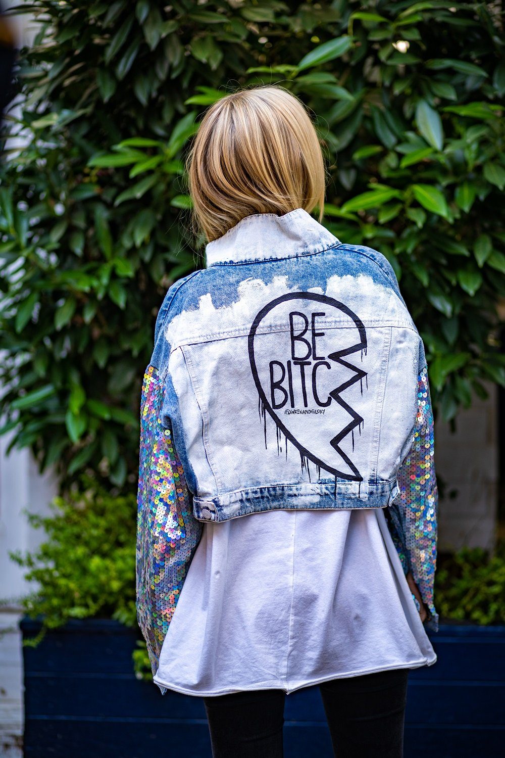 Set of 2 light blue denim wash, with sequin sleeves. Broken heart, painted in black and white, with BEST BITCHES painted on each in opposite coloring. Signed @wrenandglory.