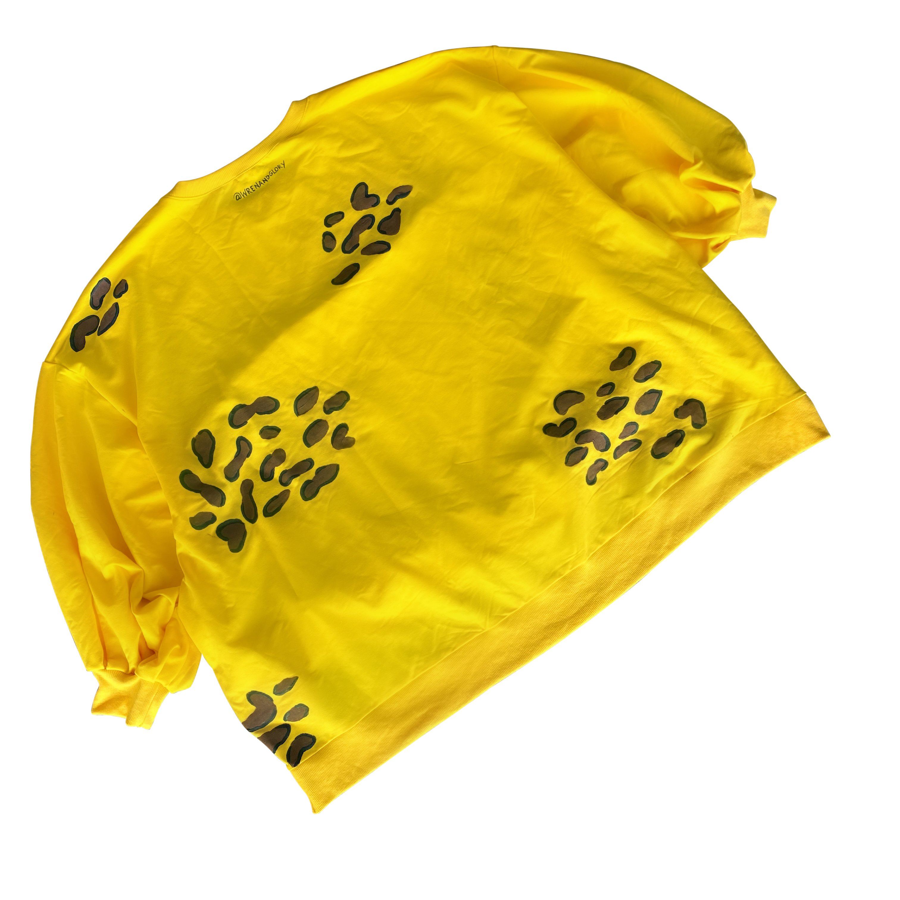 Oversized yellow crewneck sweatshirt. Cheetah pattern painted throughout in brown and black. Signed @wrenandglory.