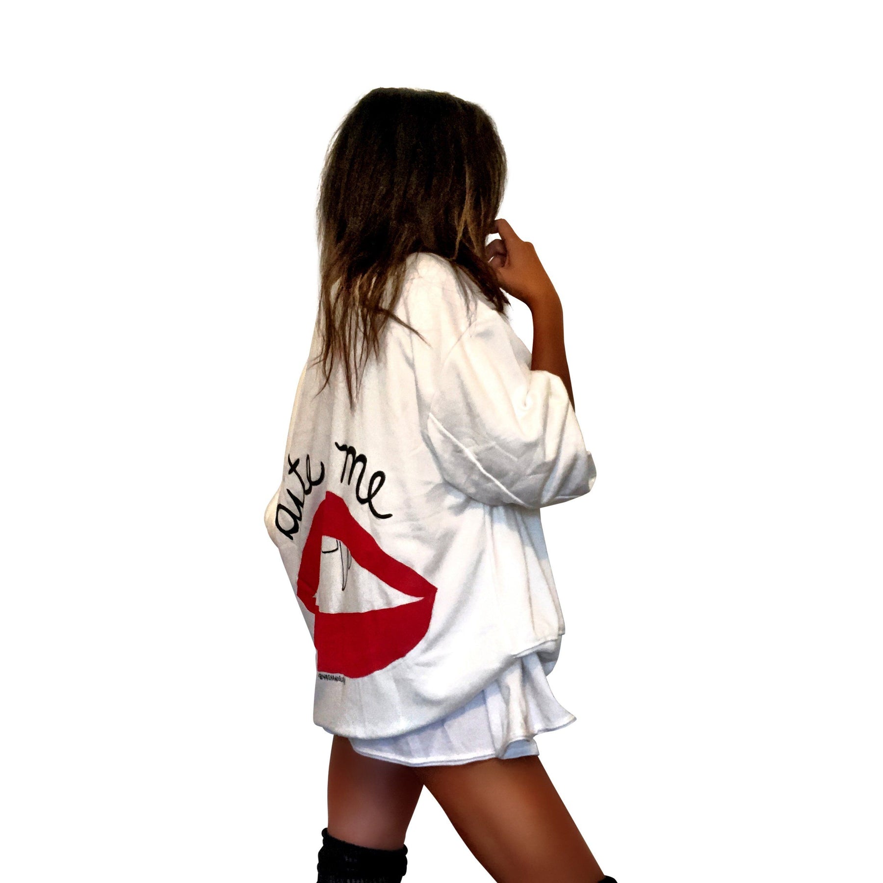 Oversized white sweatshirt. Lips and vampire teeth painted in on back, with with BITE ME painted above. Signed @wrenandglory.