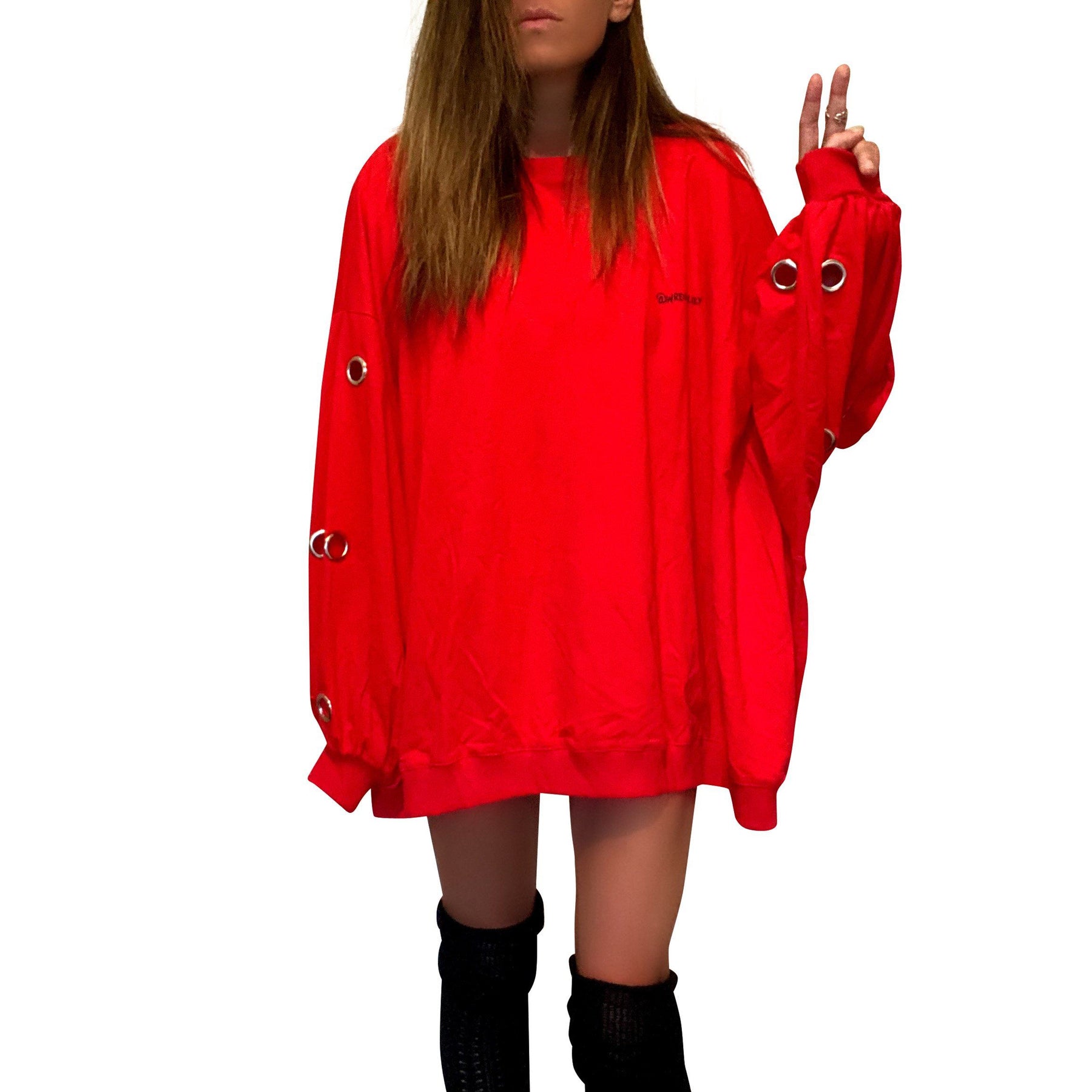 Oversized, batwing red sweatshirt with rings on sleeves. UGLY CHRISTMAS SWEATER painted on the back in black, with green paint drips coming from letters. Signed @wrenandglory