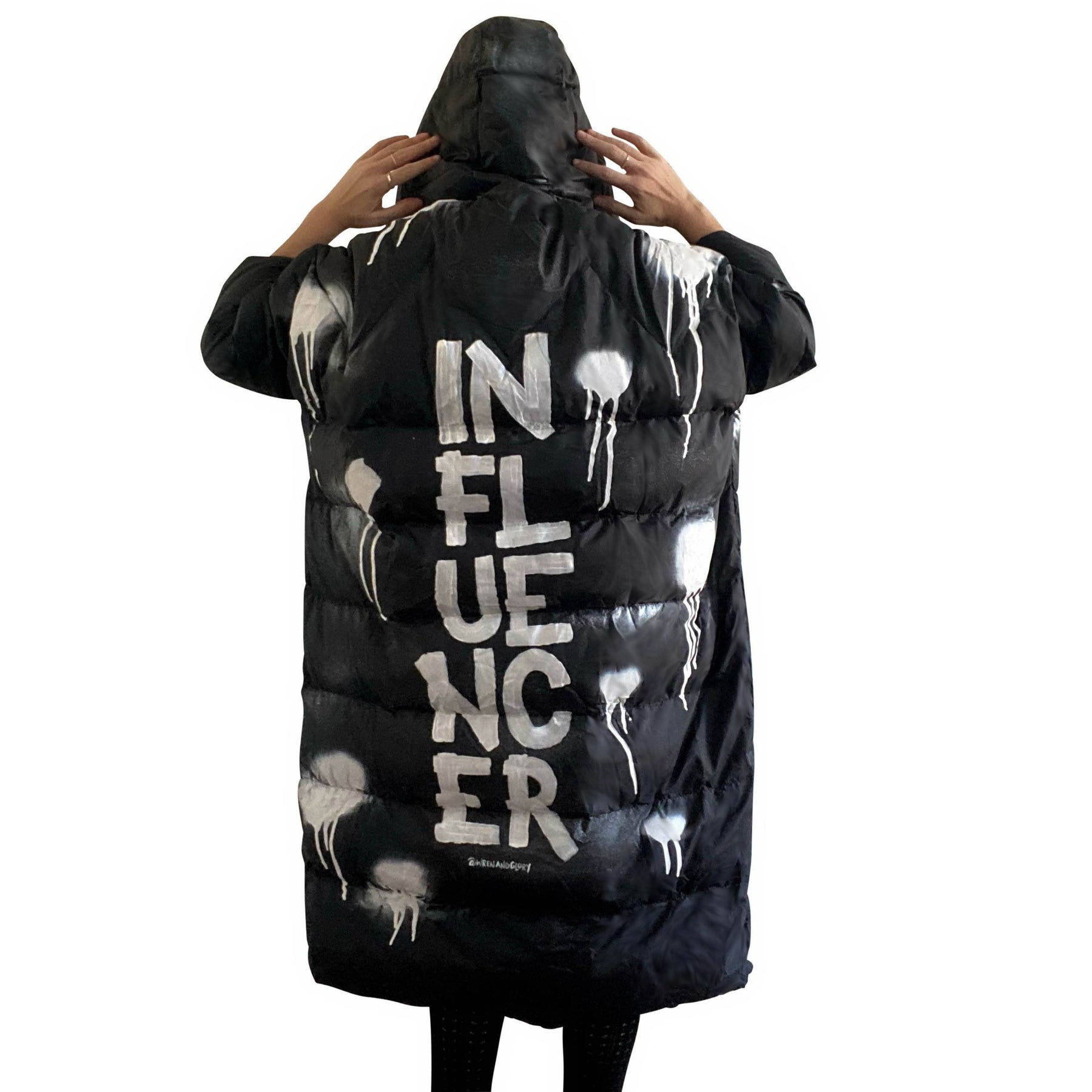 The COOLEST, MOST COMFORTABLE puffer jacket. White spray paint surrounding entire jacket, with INFLUENCER painted down the back, center, in large text. Signed @wrenandglory.