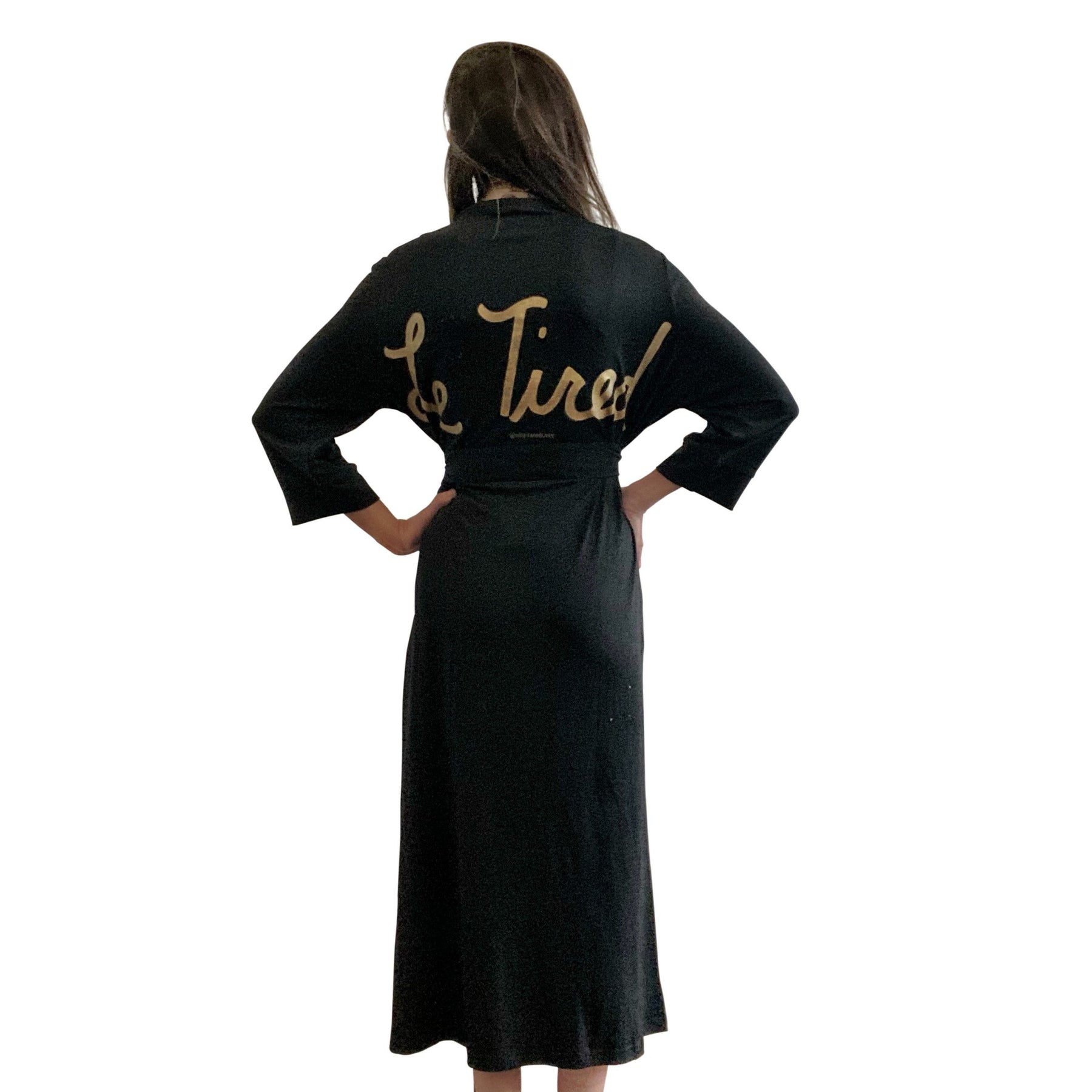 Black, super soft, stretch cotton. robe. LE TIRED painted on the back in gold. Belted, with inside ties for secure closure. Signed @wrenandglory.