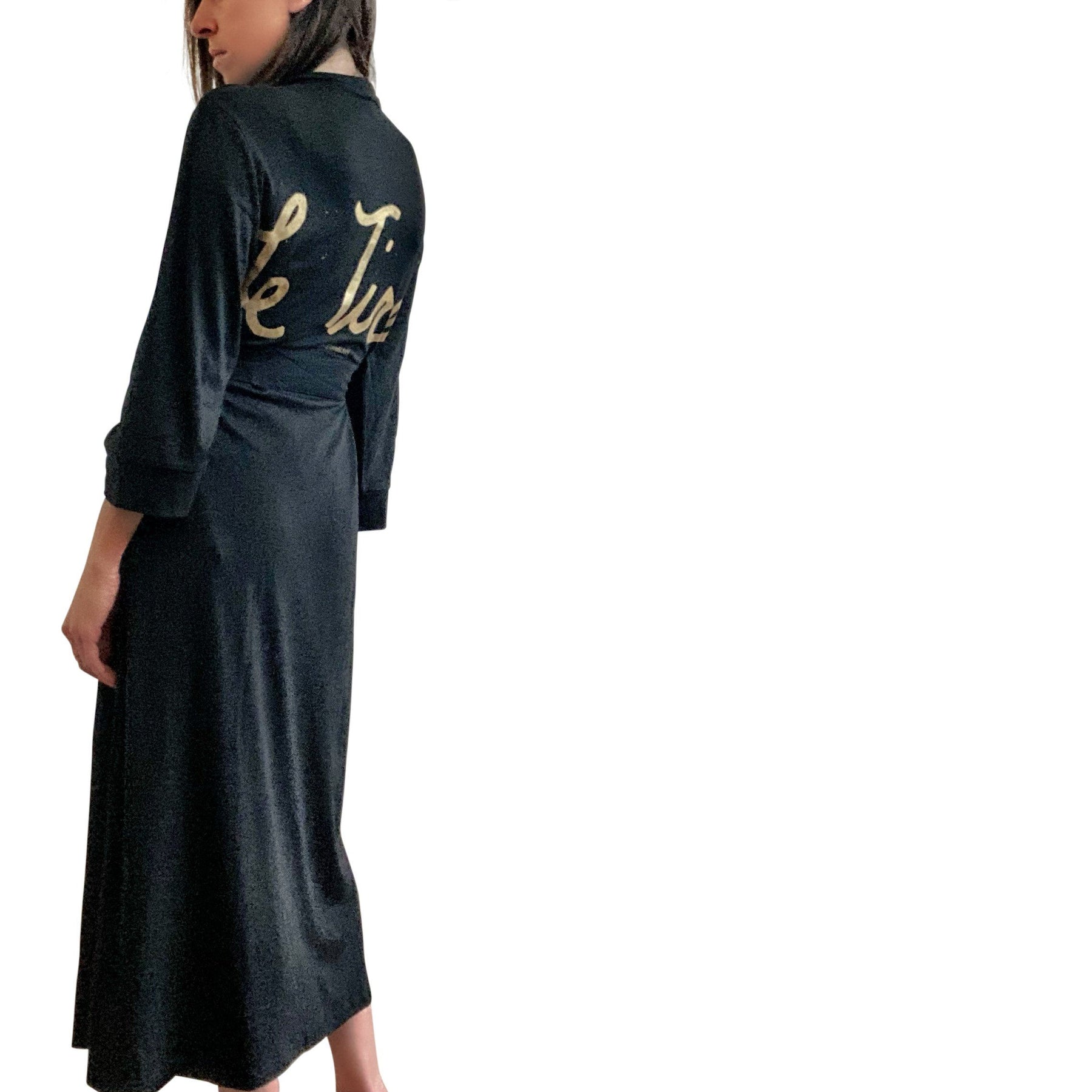 Black, super soft, stretch cotton. robe. LE TIRED painted on the back in gold. Belted, with inside ties for secure closure. Signed @wrenandglory.