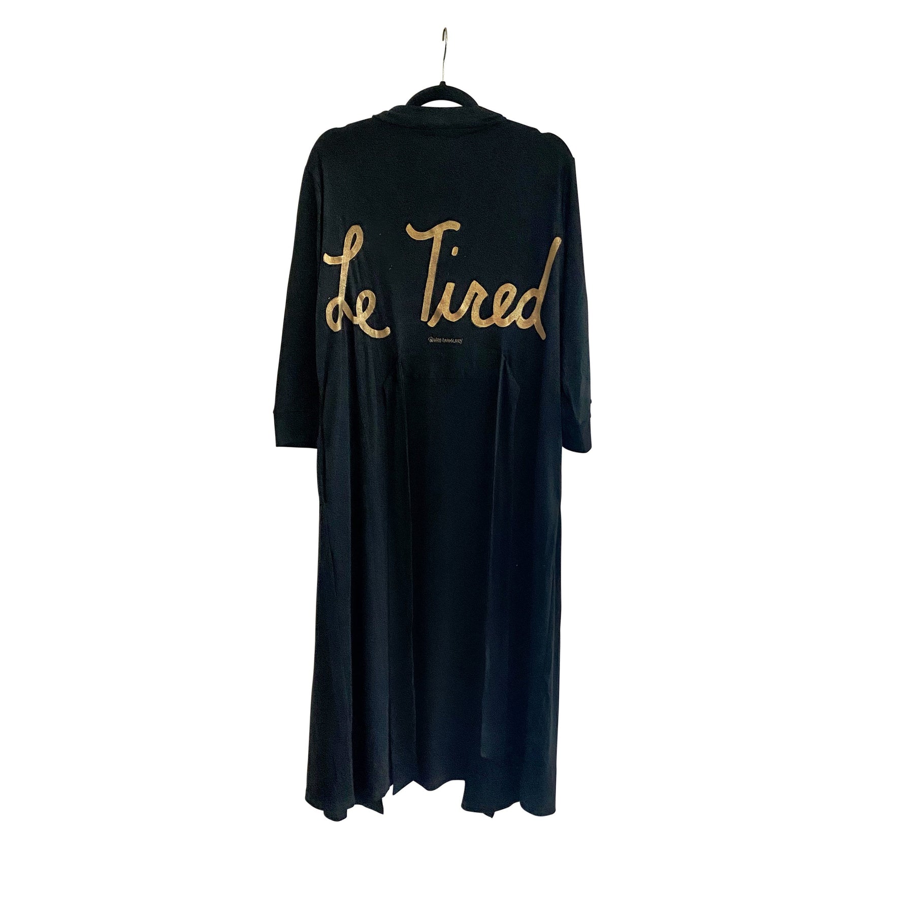 Black, super soft, stretch cotton. robe. LE TIRED painted on the back in gold. Belted, with inside ties for secure closure. Signed @wrenandglory.