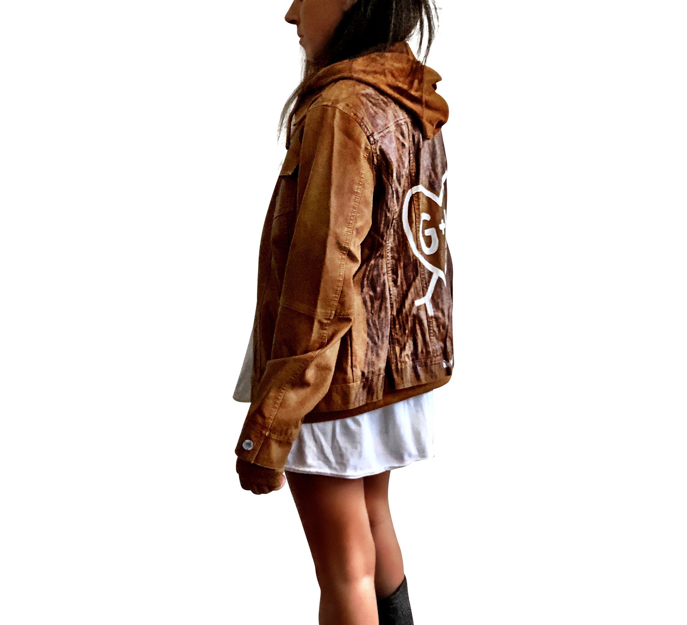 Light brown, faux leather jacket with tan sweatshirt lining the inside, with good and thumbholes at sleeves. Tree trunk painted across entire back in dark brown, with heart carved out and ' ___ + ___' painted inside. Please specify names above. Signed @wrenandglory.