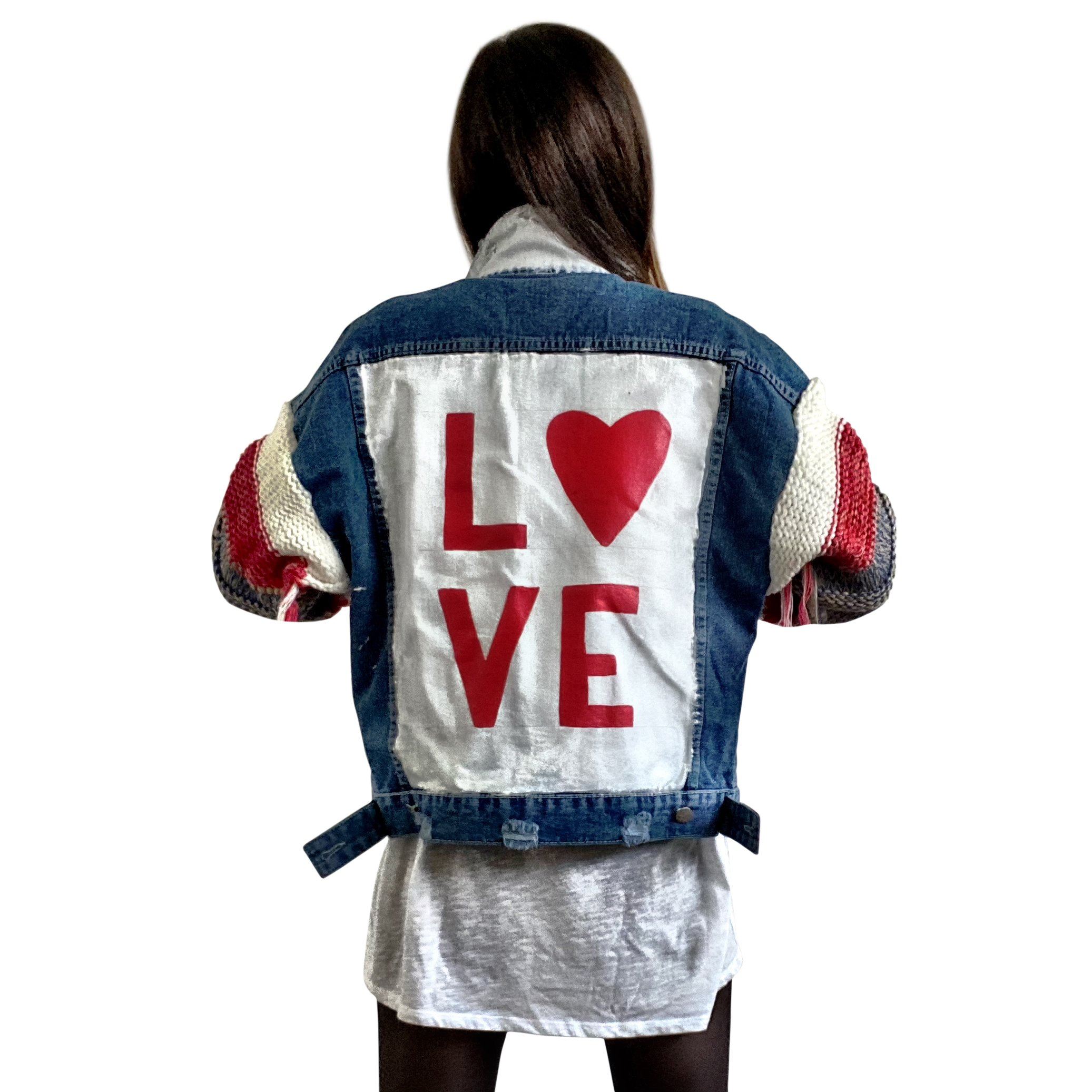 Dark blue denim jacket with super comfortable knit sleeves. White base on back, with LOVE painted over in red, with a heart Signed @wrenandglory.