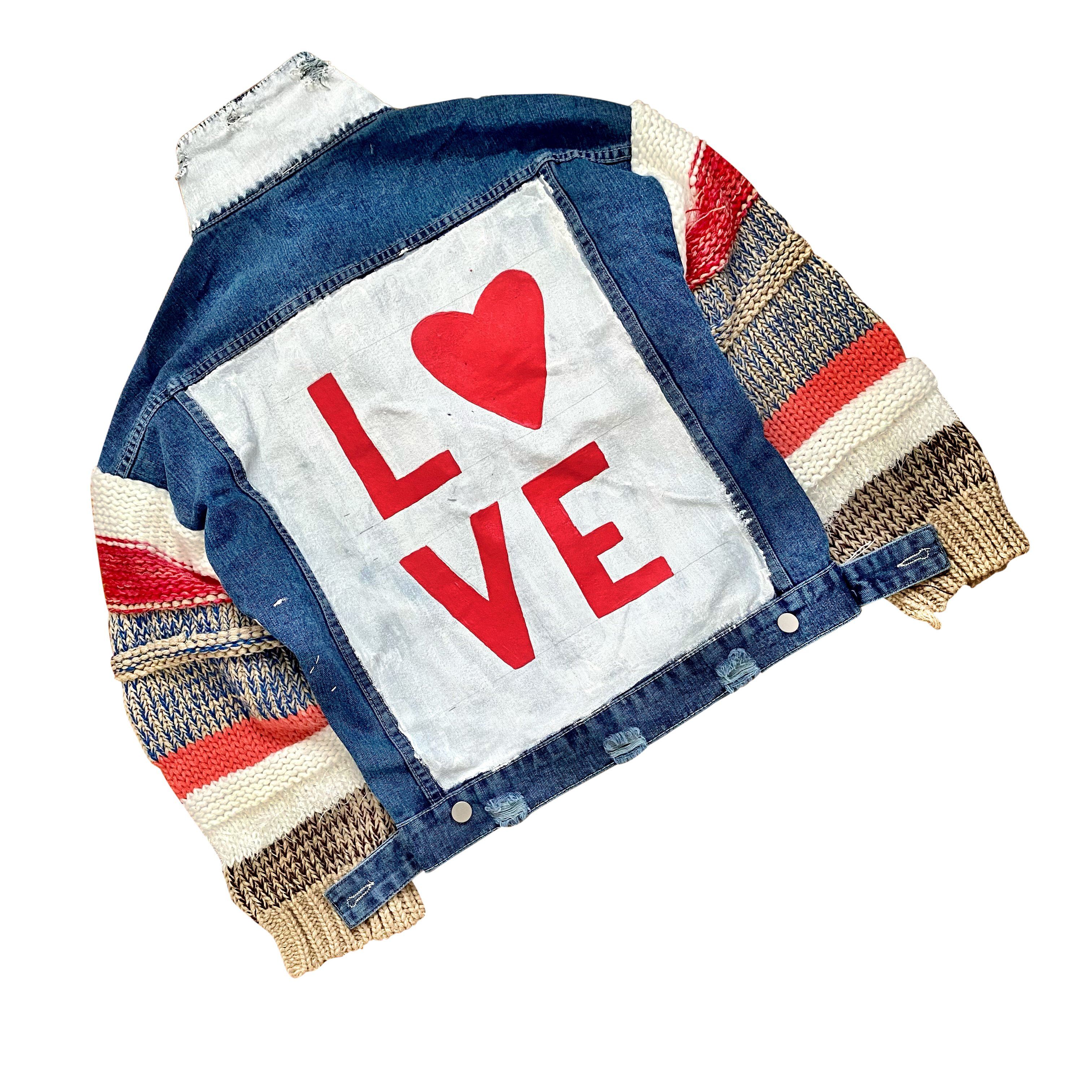 Dark blue denim jacket with super comfortable knit sleeves. White base on back, with LOVE painted over in red, with a heart Signed @wrenandglory.