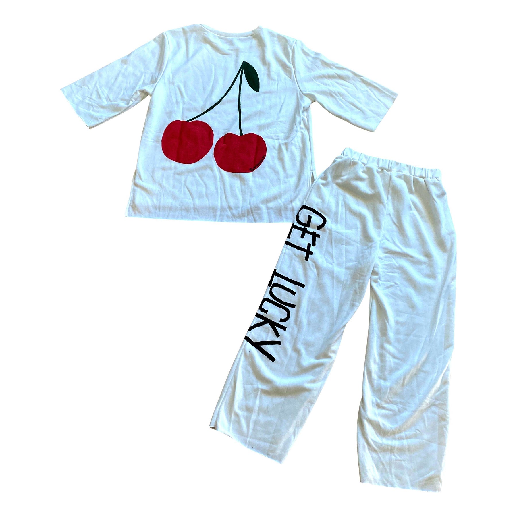 The perfect white sweatshirt & sweatpant loungewear set. Large cherries painted on back of sweatshirt, with GET LUCKY painted in black down leg of pant. Signed @wrenandglory on both top and bottom.