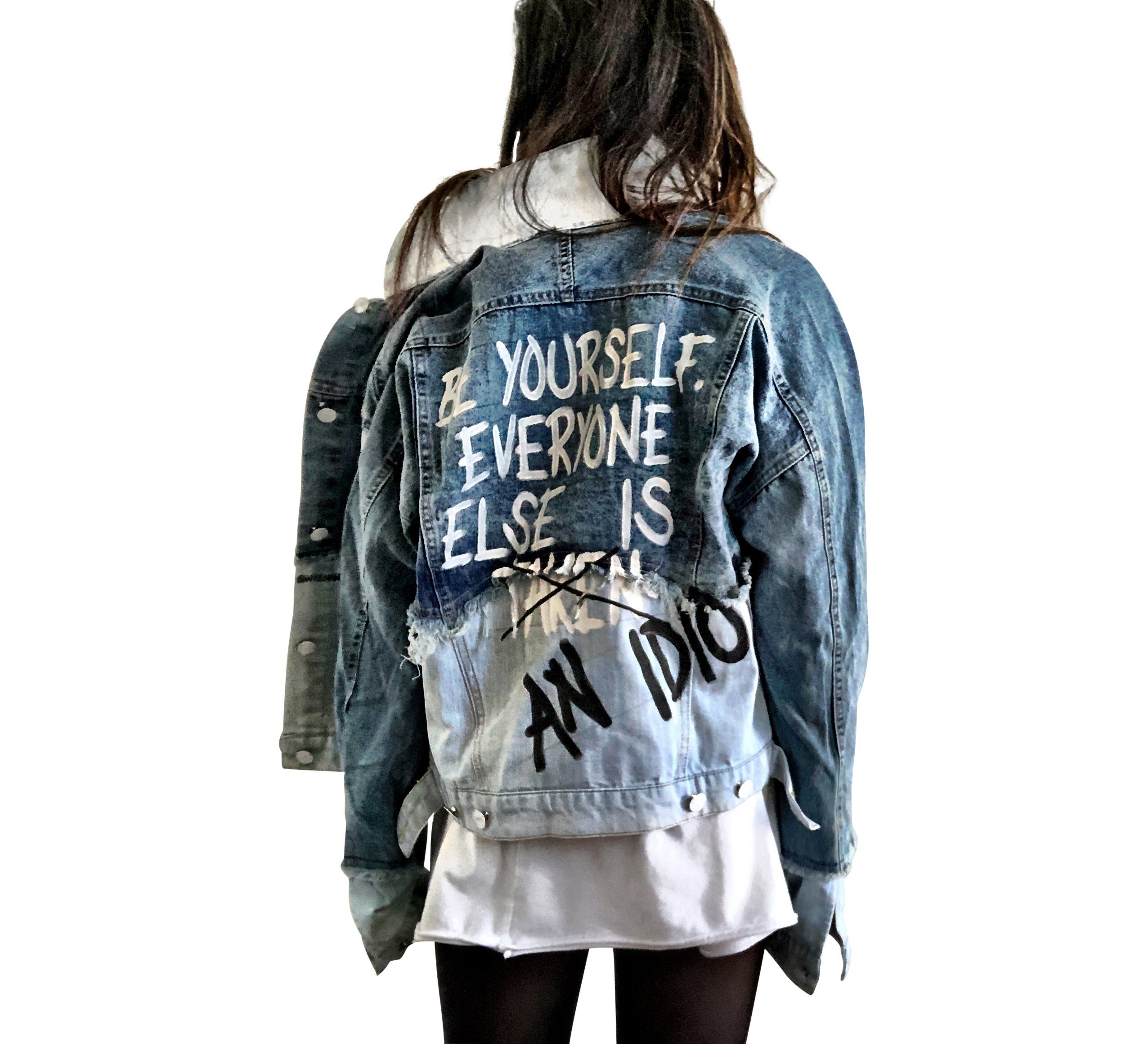 2 tone blue denim wash. BE YOURSELF. EVERYONE ELSE IS TAKEN (CROSSED OUT) AN IDIOT painted in white & black on back. Signed @wrenandglory.