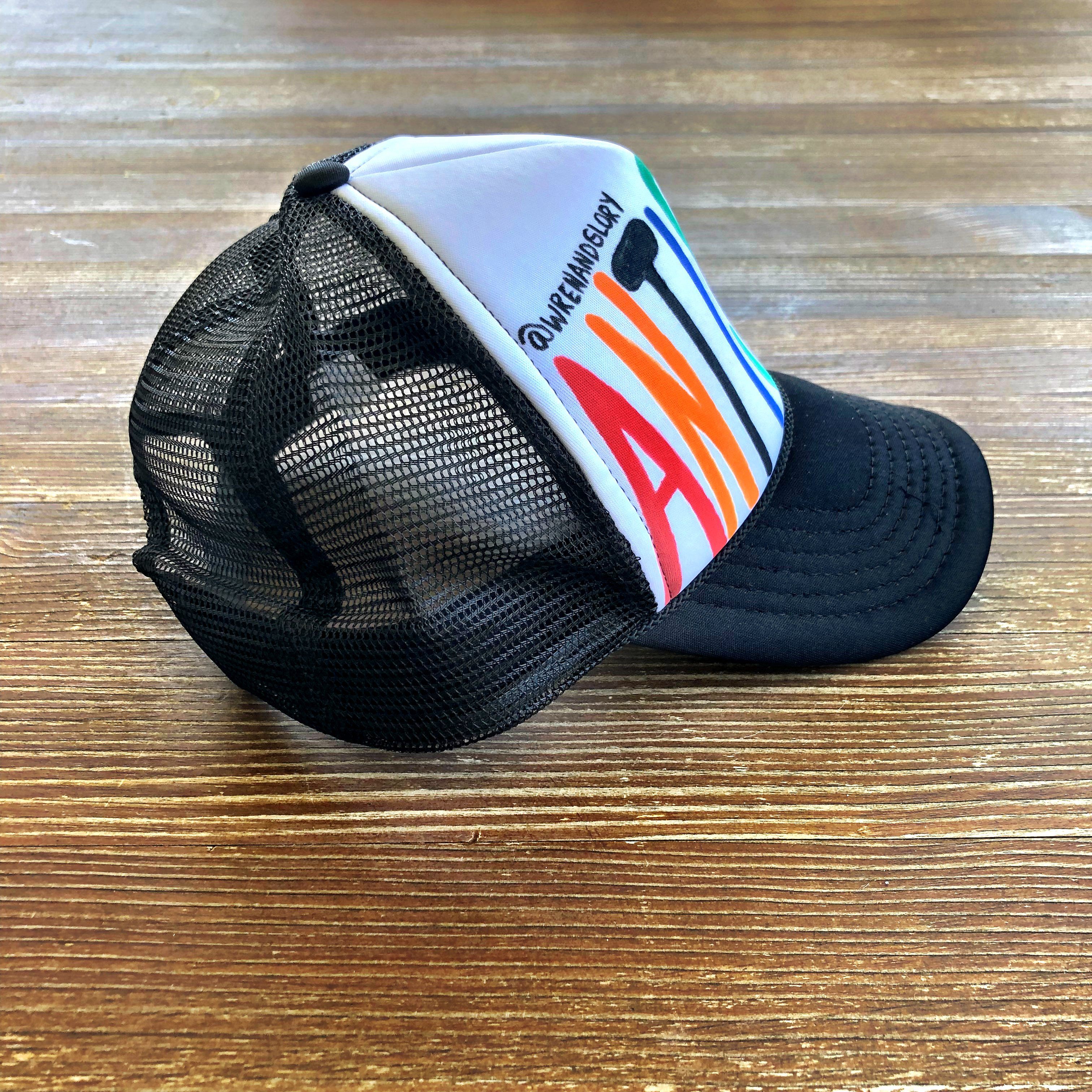 White and black trucker hat. Hand painted ANTI SOCIAL in multi colors. Signed @wrenandglory