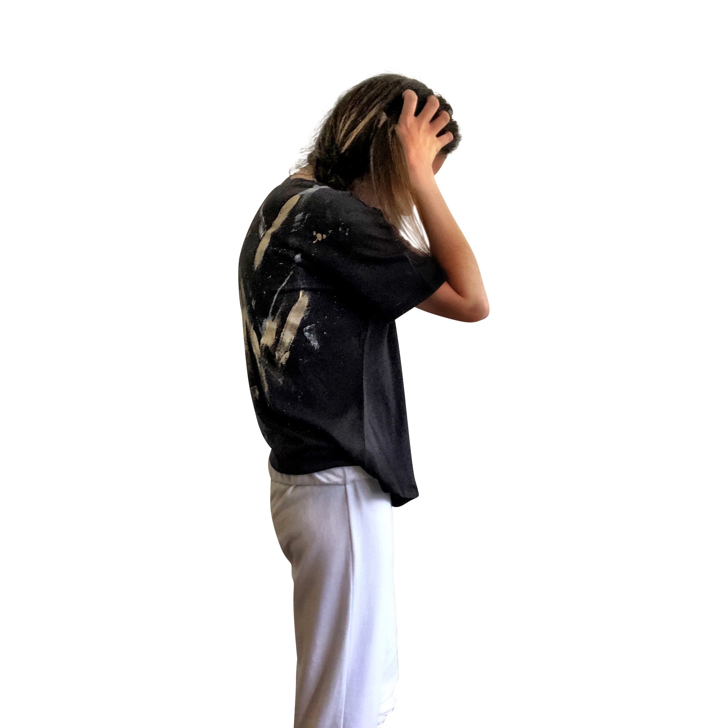 The perfect cropped black T shirt. Assorted color metallics and white splatter and stripes painted on back, with small stars painted on front, upper left side in gold. Signed @wrenandglory.