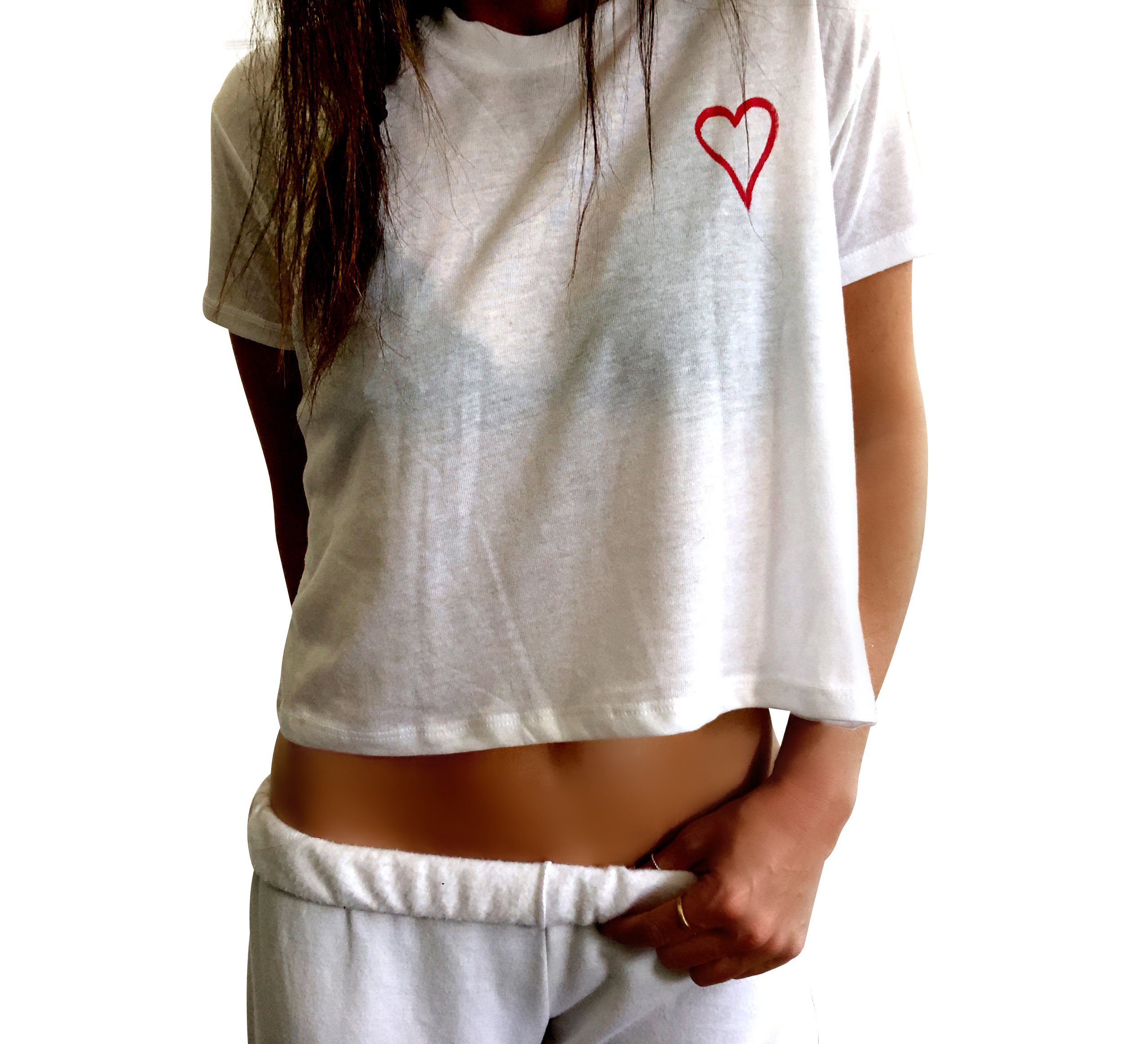 The perfect cropped white T shirt. Assorted color splatter and stripes painted on back, with small heart painted on front, upper left side in red. Signed @wrenandglory.