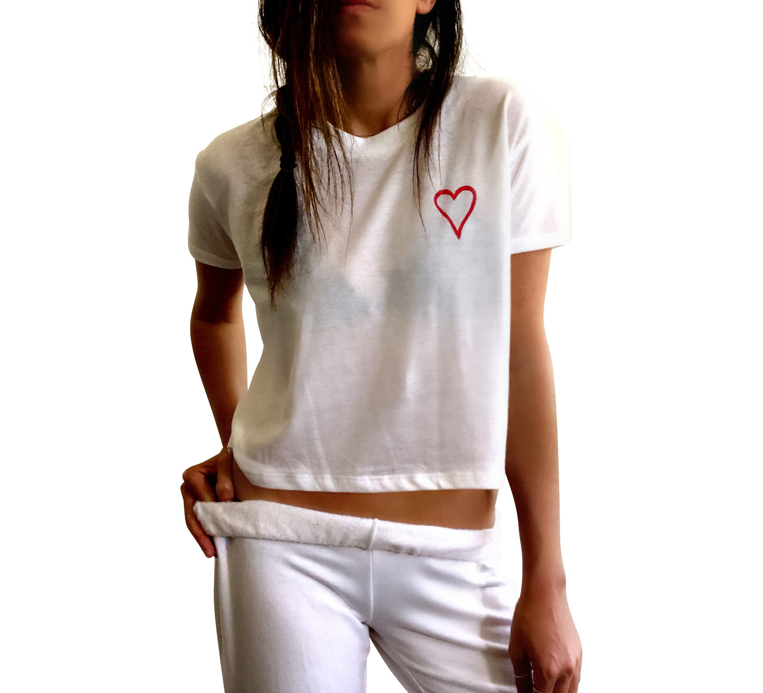 The perfect cropped white T shirt. Assorted color splatter and stripes painted on back, with small heart painted on front, upper left side in red. Signed @wrenandglory.