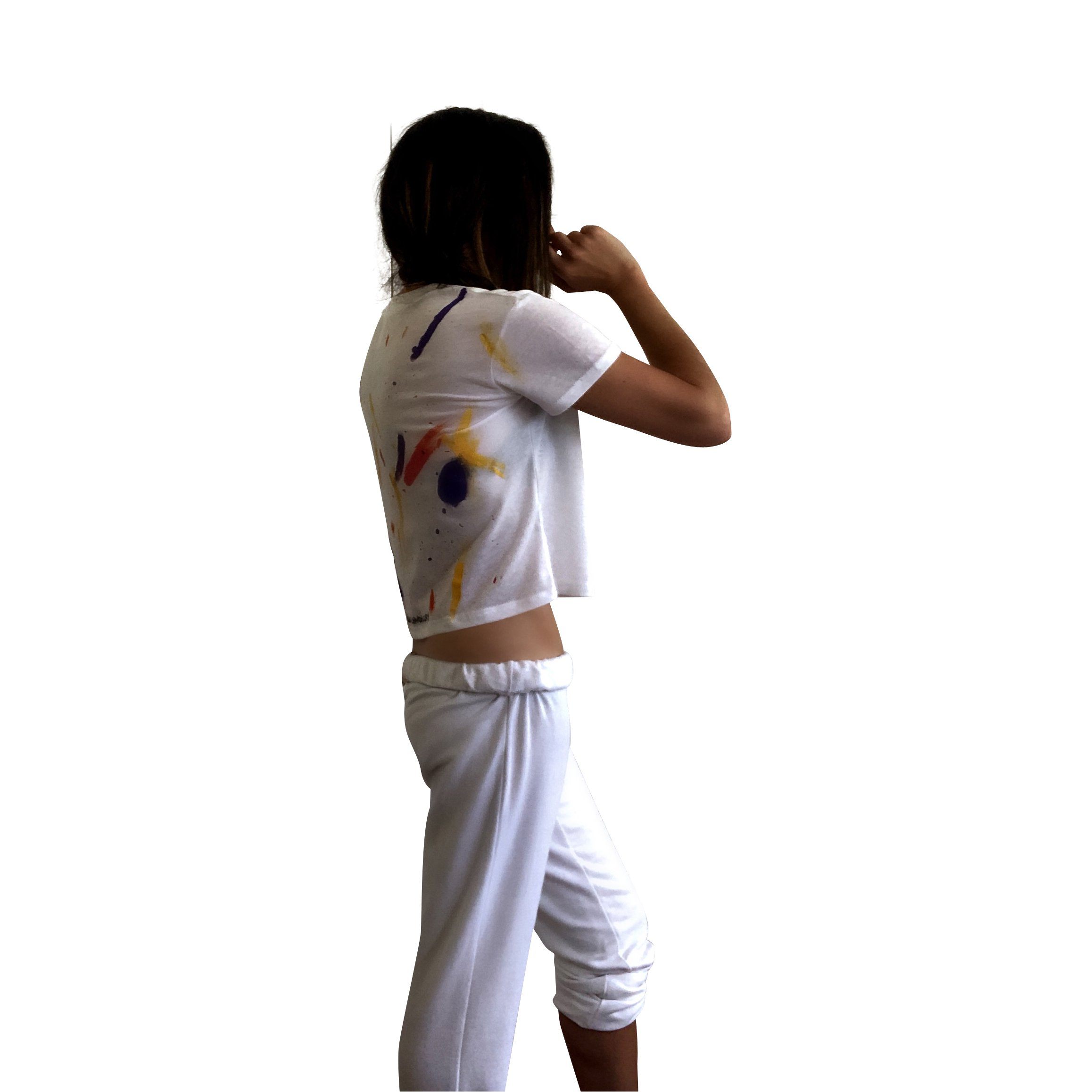 The perfect cropped white T shirt. Assorted color splatter and stripes painted on back, with small heart painted on front, upper left side in red. Signed @wrenandglory.