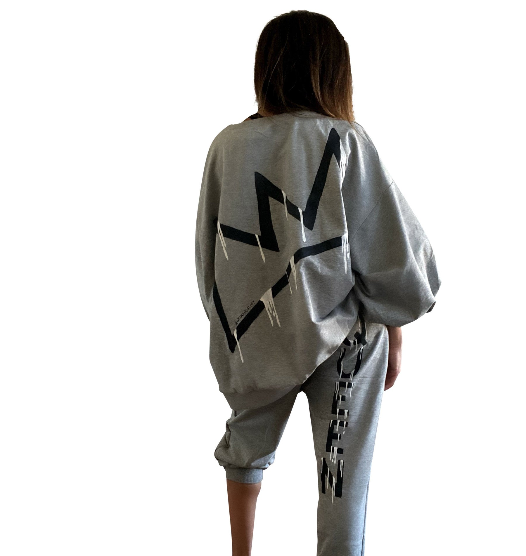 The perfect oversized sweatshirt & jogger loungewear set. TOP: Large crown painted on back in black, with white paint drips. QUEEN painted in black, on front left chest. BOTTOM: QUEEN painted on back going down leg in black, with white paint drips. Assorted sized crowns painted in black and white on front. Signed @wrenandglory on both top and bottom.