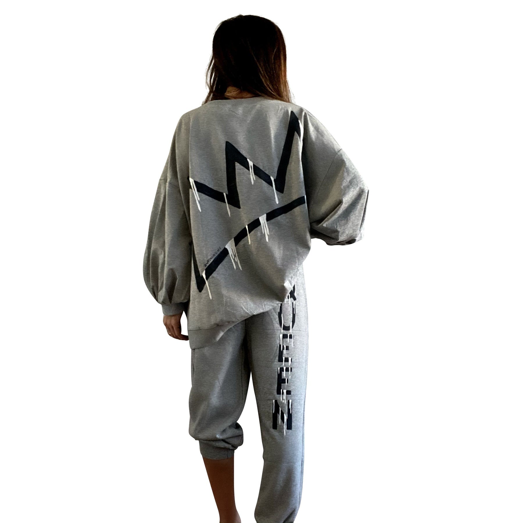 The perfect oversized sweatshirt & jogger loungewear set. TOP: Large crown painted on back in black, with white paint drips. QUEEN painted in black, on front left chest. BOTTOM: QUEEN painted on back going down leg in black, with white paint drips. Assorted sized crowns painted in black and white on front. Signed @wrenandglory on both top and bottom.