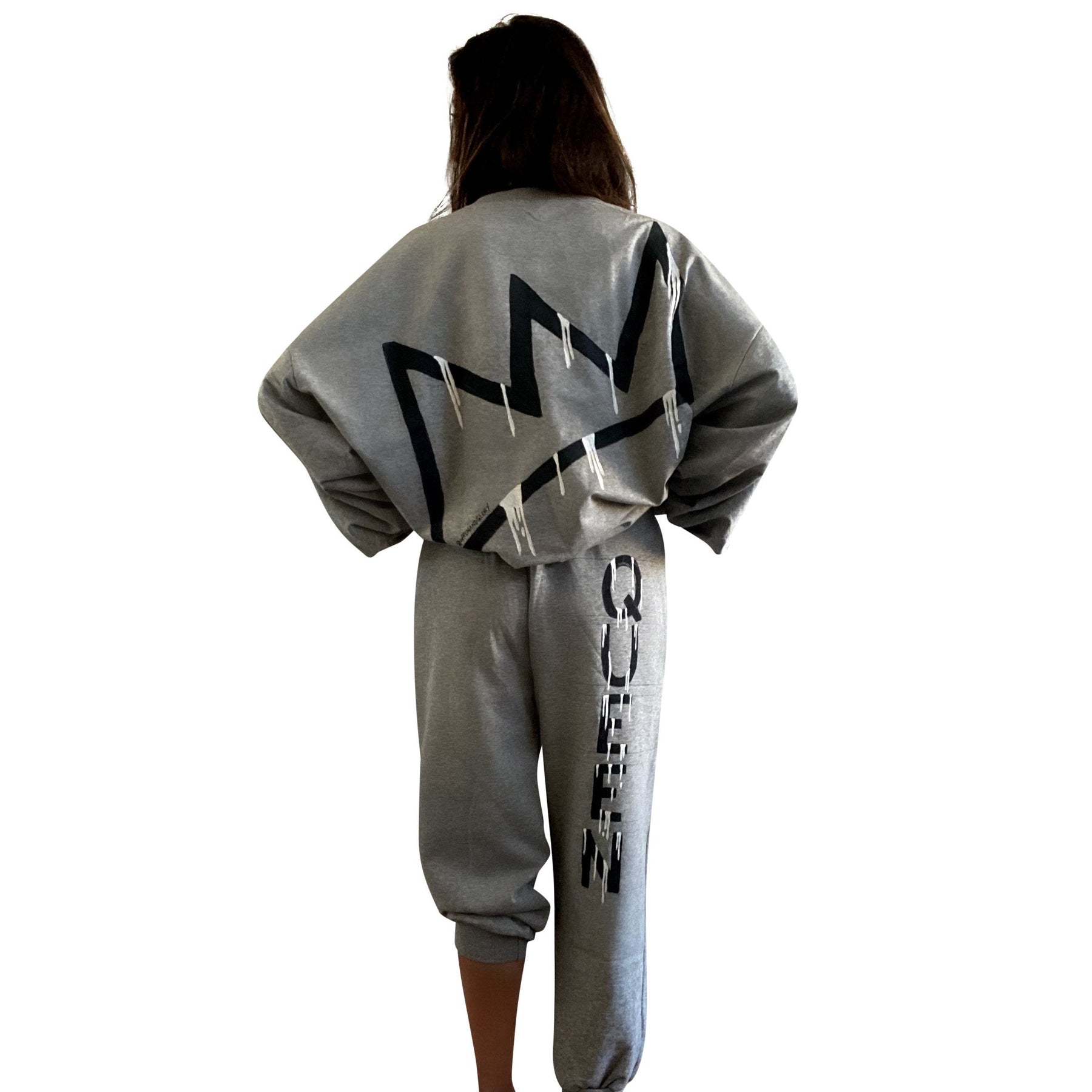 The perfect oversized sweatshirt & jogger loungewear set. TOP: Large crown painted on back in black, with white paint drips. QUEEN painted in black, on front left chest. BOTTOM: QUEEN painted on back going down leg in black, with white paint drips. Assorted sized crowns painted in black and white on front. Signed @wrenandglory on both top and bottom.