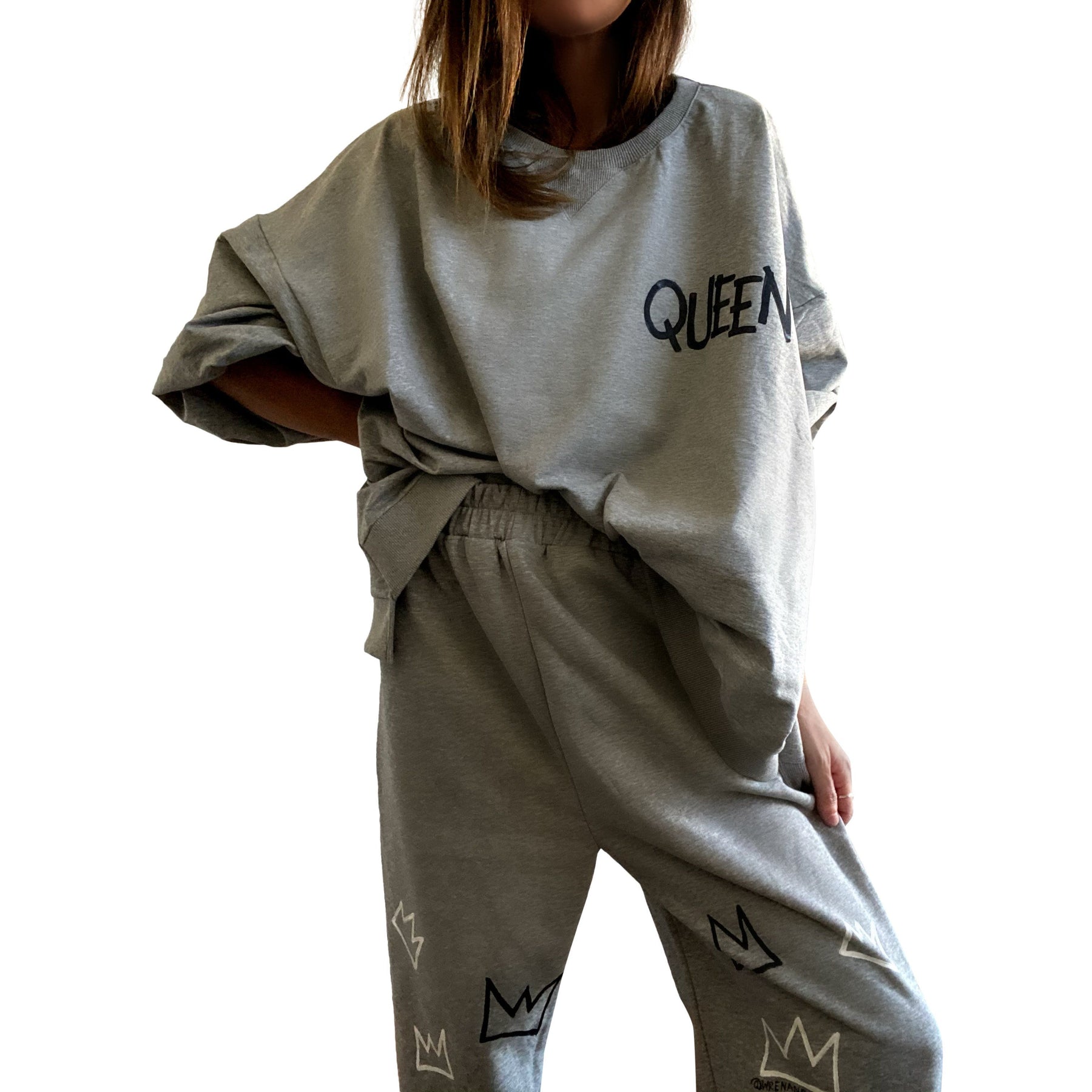 The perfect oversized sweatshirt & jogger loungewear set. TOP: Large crown painted on back in black, with white paint drips. QUEEN painted in black, on front left chest. BOTTOM: QUEEN painted on back going down leg in black, with white paint drips. Assorted sized crowns painted in black and white on front. Signed @wrenandglory on both top and bottom.