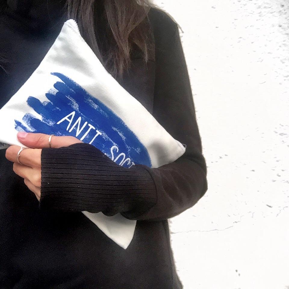 White denim zippered pouch. Hand painted 'ANTI SOCIAL' design. Signed @wrenandglory.