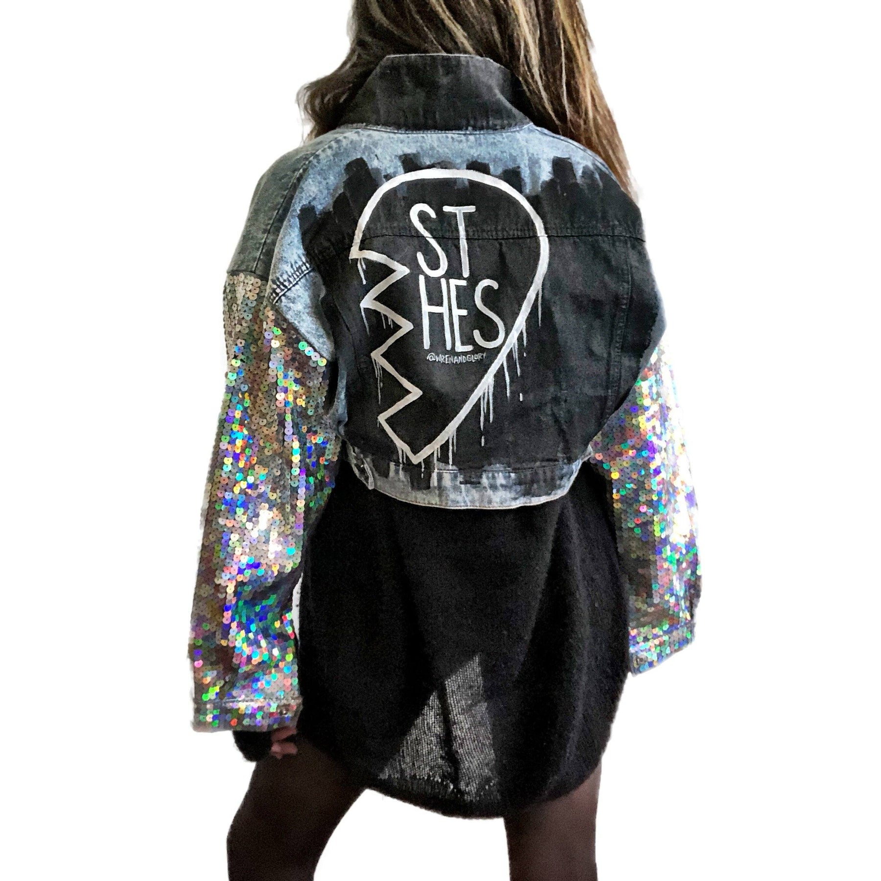 Set of 2 light blue denim wash, with sequin sleeves. Broken heart, painted in black and white, with BEST BITCHES painted on each in opposite coloring. Signed @wrenandglory.