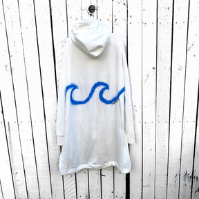 Oversized white sweatshirt dress. Blue wave painted along entire sweatshirt, on chest area, with APRES BEACH painted in black on front pocket. Signed @wrenandglory.