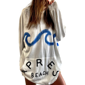 Oversized white sweatshirt dress. Blue wave painted along entire sweatshirt, on chest area, with APRES BEACH painted in black on front pocket. Signed @wrenandglory.