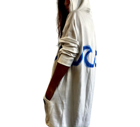 Oversized white sweatshirt dress. Blue wave painted along entire sweatshirt, on chest area, with APRES BEACH painted in black on front pocket. Signed @wrenandglory.