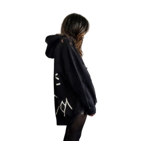 The perfect oversized black distressed hoodie. APRES SKI painted on back in semi circle, with mountain outline along bottom. Signed @wrenandglory