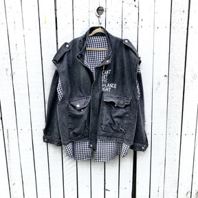 Light black denim, with black and white checkered flannel insert. 'I HAVE ONLY TWO EMOTIONS, CAREFUL FEAR AND DEAD DEVOTION' painted in white on back. ''I CANT GET THE BALANCE RIGHT' painted in white, in small, on front. Signed @wrenandglory.