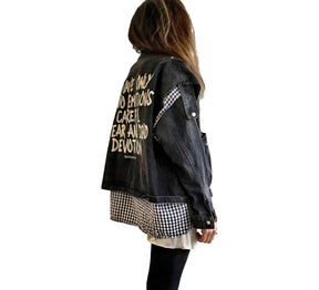 Light black denim, with black and white checkered flannel insert. 'I HAVE ONLY TWO EMOTIONS, CAREFUL FEAR AND DEAD DEVOTION' painted in white on back. ''I CANT GET THE BALANCE RIGHT' painted in white, in small, on front. Signed @wrenandglory.