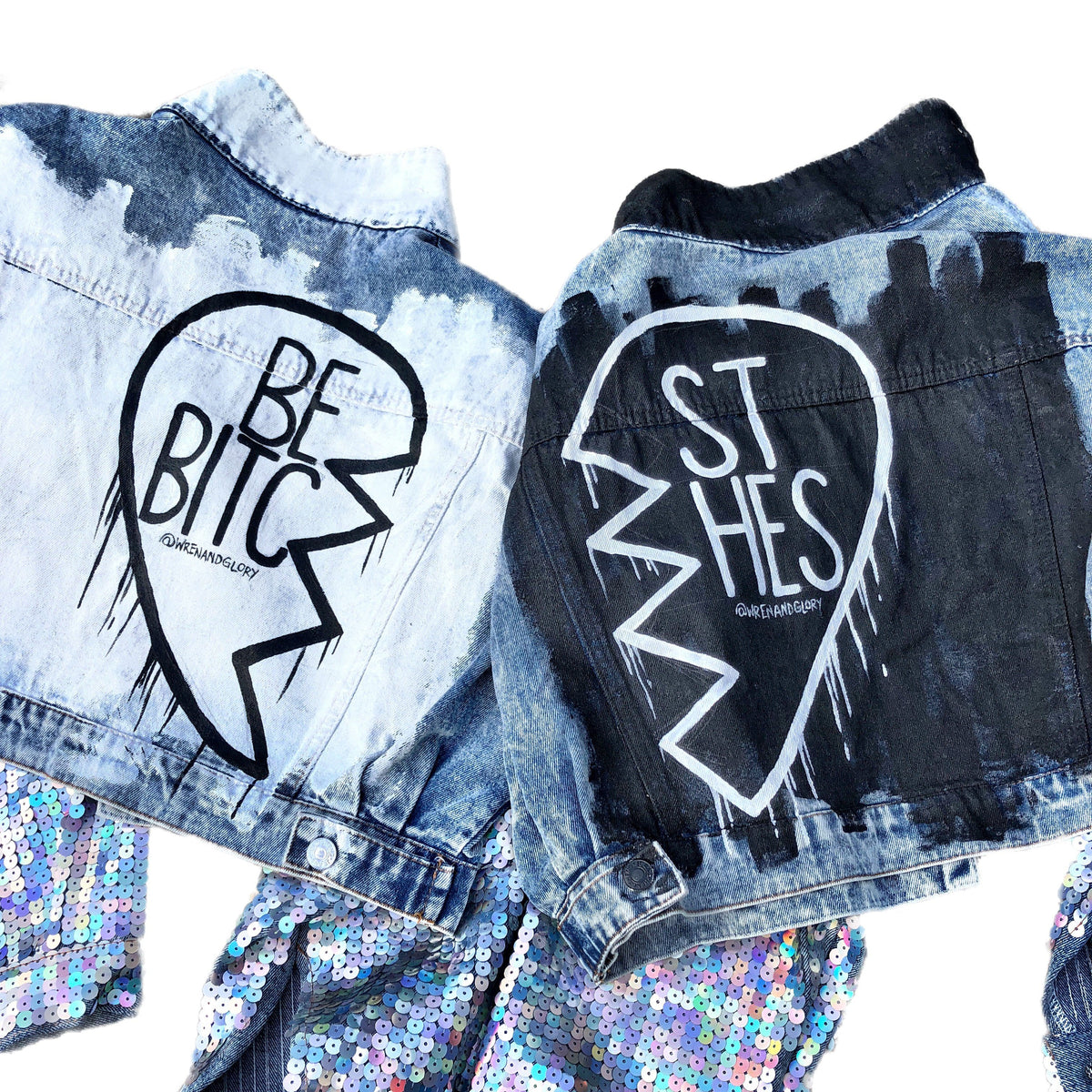 Set of 2 light blue denim wash, with sequin sleeves. Broken heart, painted in black and white, with BEST BITCHES painted on each in opposite coloring. Signed @wrenandglory.