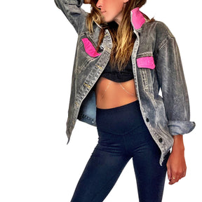 Faded black denim. BE THE SH*T logo painted on back in neon effect in bright pink. Collar and front pockets painted white. Signed @wrenandglory.