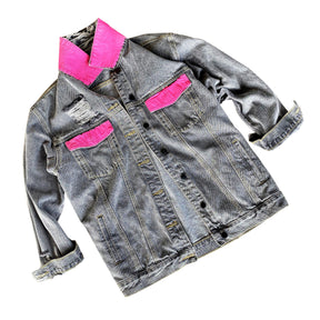 Faded black denim. BE THE SH*T logo painted on back in neon effect in bright pink. Collar and front pockets painted white. Signed @wrenandglory.
