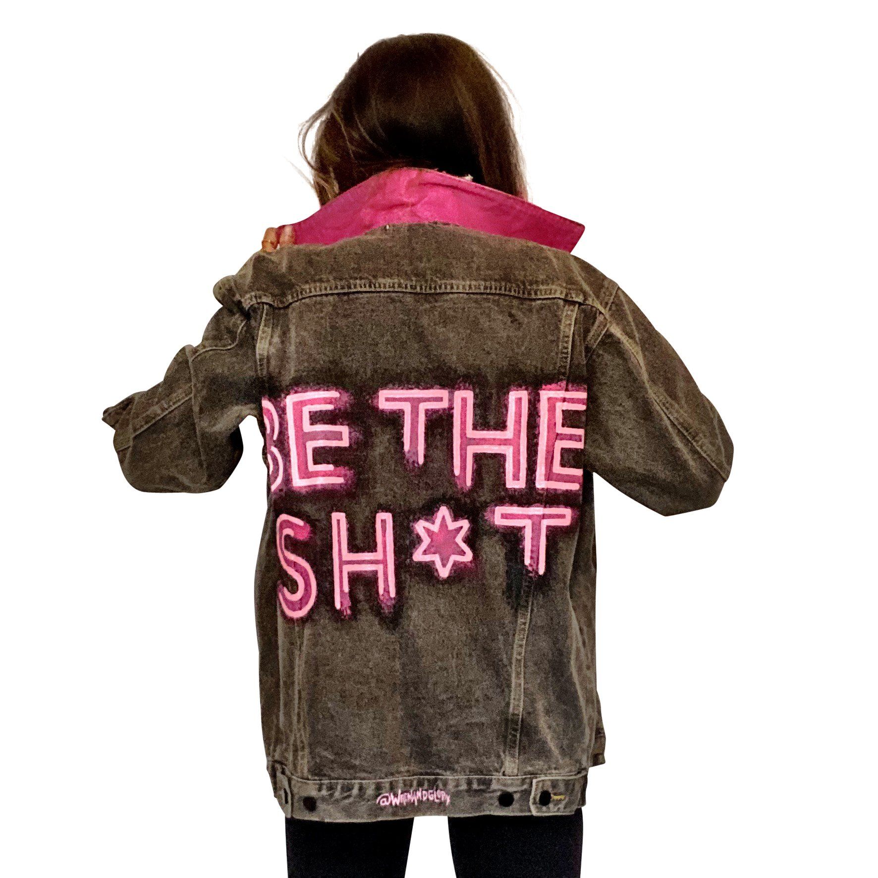 Faded black denim. BE THE SH*T logo painted on back in neon effect in bright pink. Collar and front pockets painted white. Signed @wrenandglory.