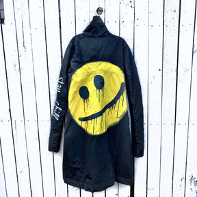 The COOLEST puffer jacket. Large smiley painted on back in yellow, with black drip eyes and mouth. STAY CHILL painted in white on sleeve. Signed @wrenandglory.