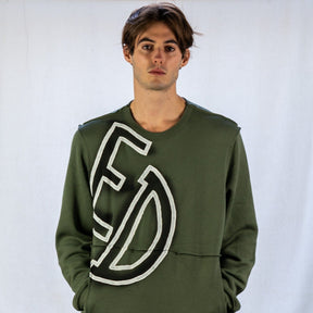 Army green or Tan crewneck sweatshirt. CANCELED painted in black spray paint, with white outline, overlapping from front to back. Signed @wrenandglory.