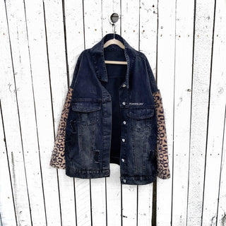Black denim jacket with super comfortable leopard pattern sleeves. Large white cassette tape painted on back, with white flowers and leaves sprouting out. Signed @wrenandglory.